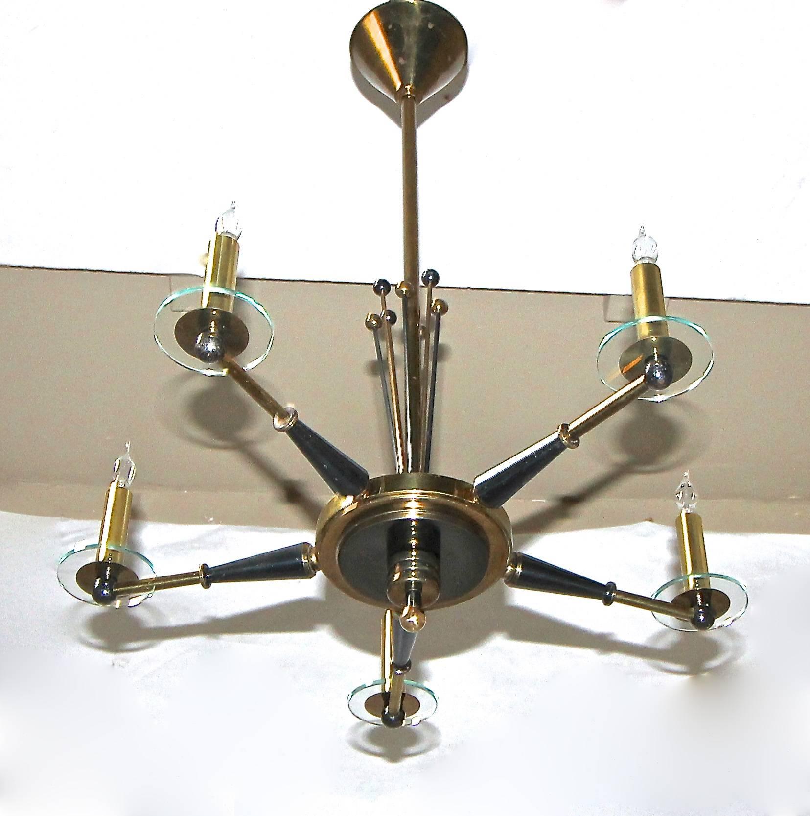 French 5-light stylized polished and blackened brass chandelier attributed to Maison Jansen. Nice over detailing with glass bobeche candle cups and elongated rods and round beaded tops.