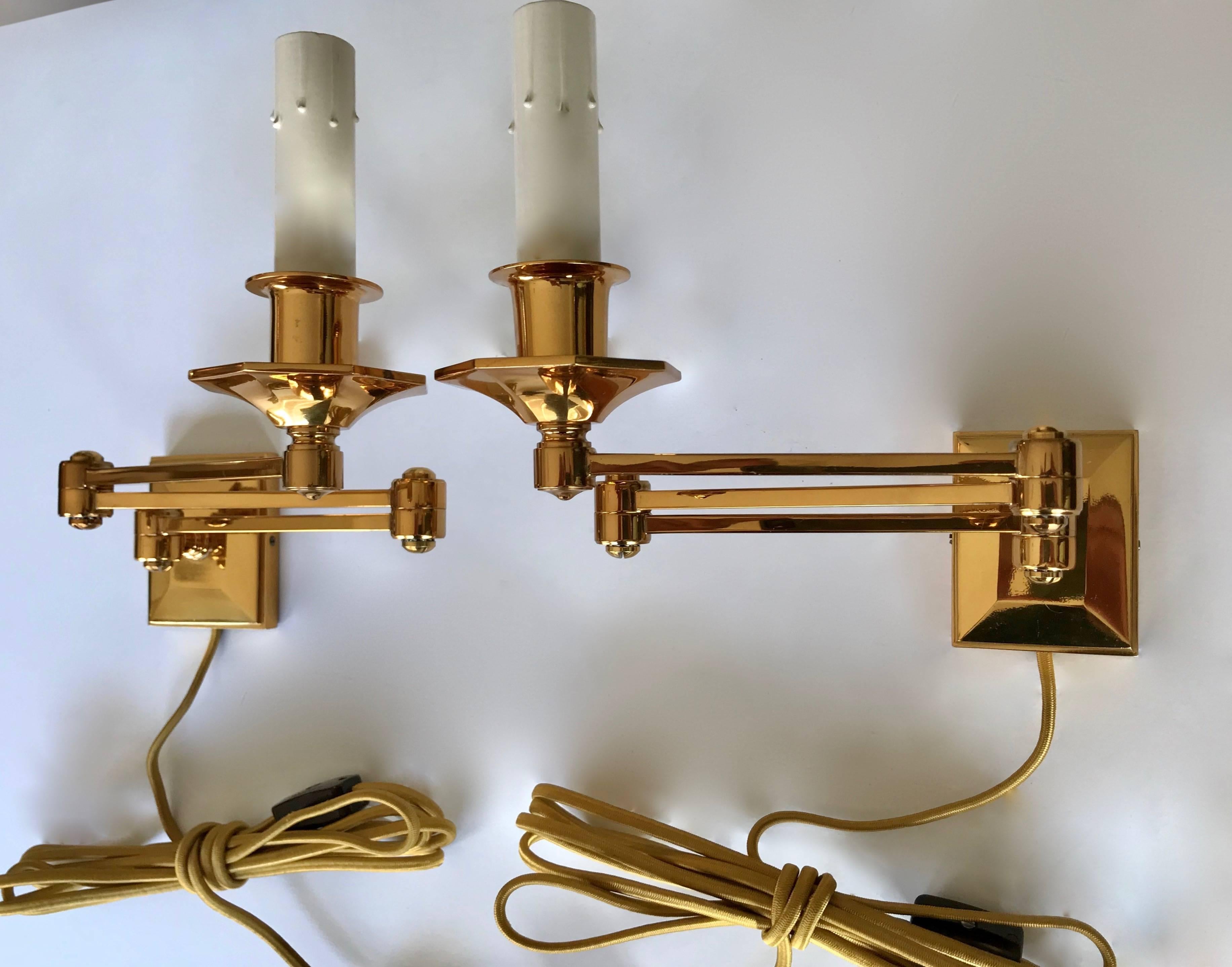 A pair of English style brass swing arm wall sconces, wall-mounted with rayon covered cords. Beautiful quality in a smaller scale. Perfect for adding to either side of a headboard without having to add junction boxes.

Measures: 7