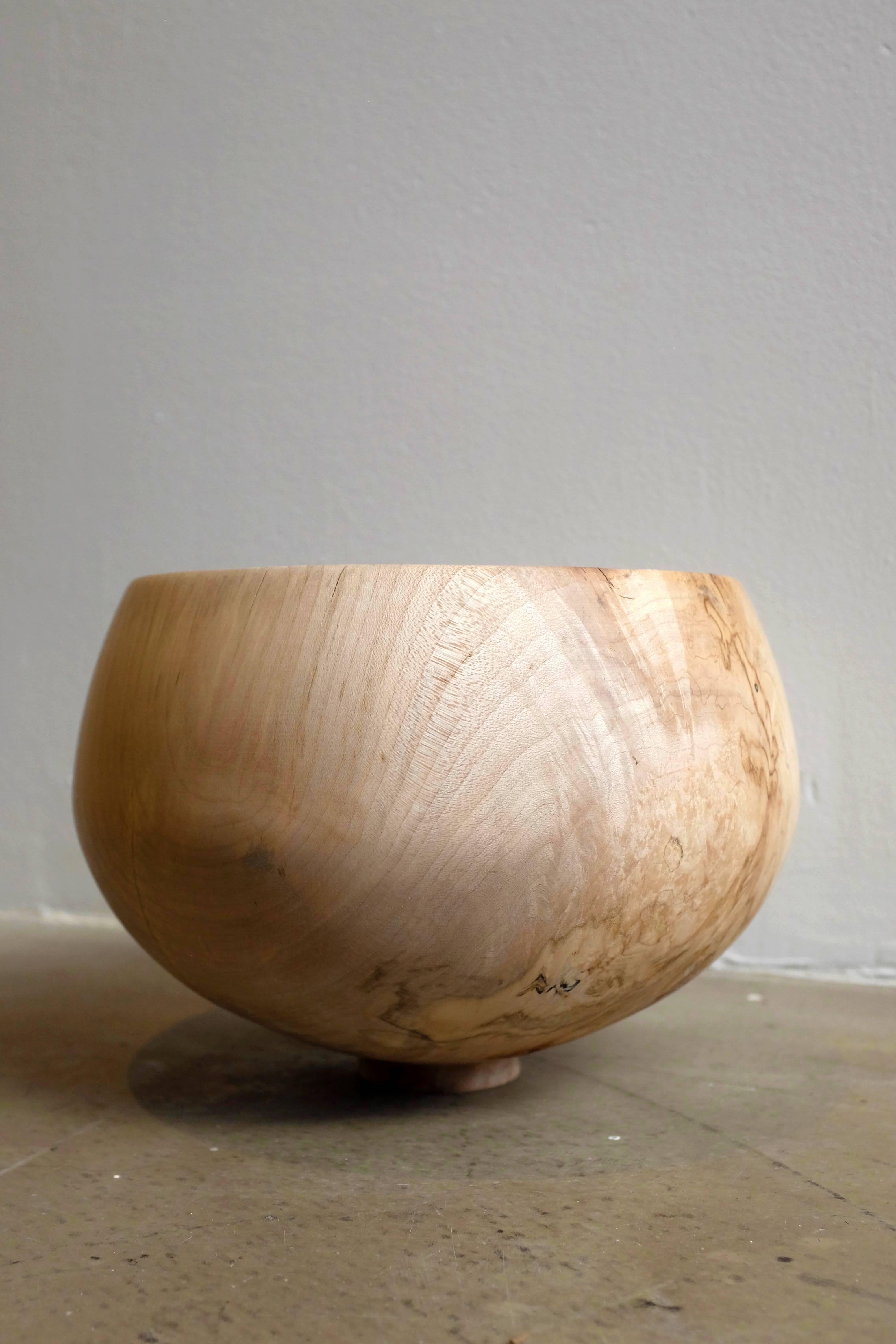 Light and beautifully textured, these sycamore offering bowls swell in shape and each live on a narrow, sturdy foot. Hand-turned, the vases' textures are smooth and inviting as the sycamore wood creates ripples and spots that catch light, presenting