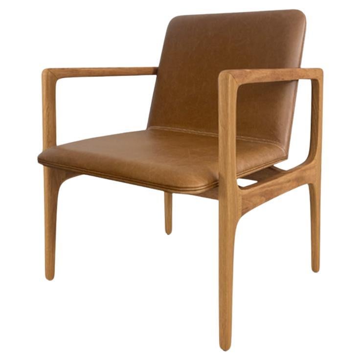 Modern and minimalist “Oscar” armchair, made of solid wood upholstered in fabric