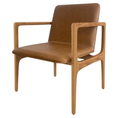 Modern and minimalist “Oscar” armchair, made of solid wood upholstered in fabric