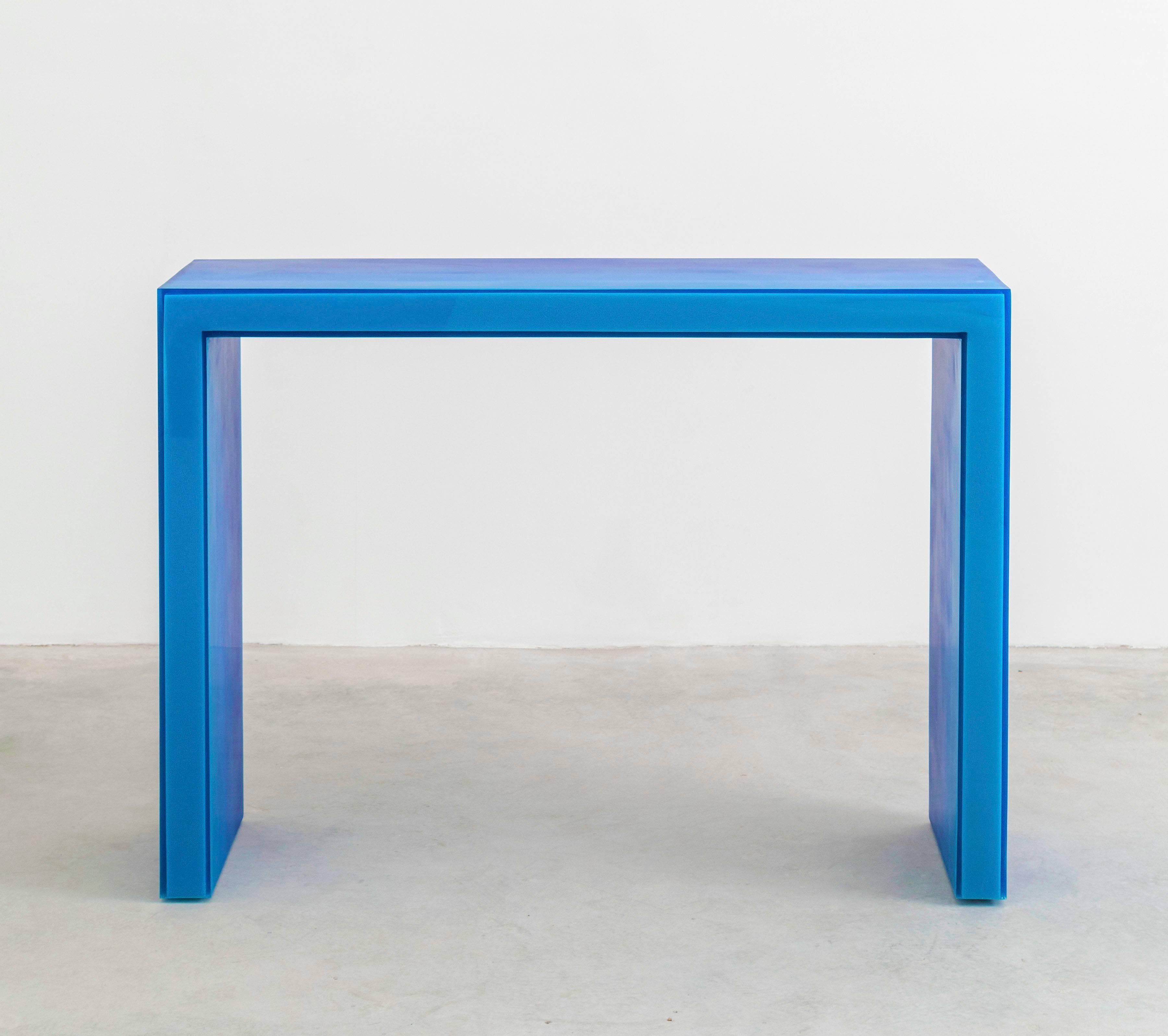 This console uses Facture Studio's gradient style to transition in six layers from a deep opaque to water clear blue over a light blue resin core. The interior and exterior facets are sanded to a buttery smooth finish while the front edge is buffed