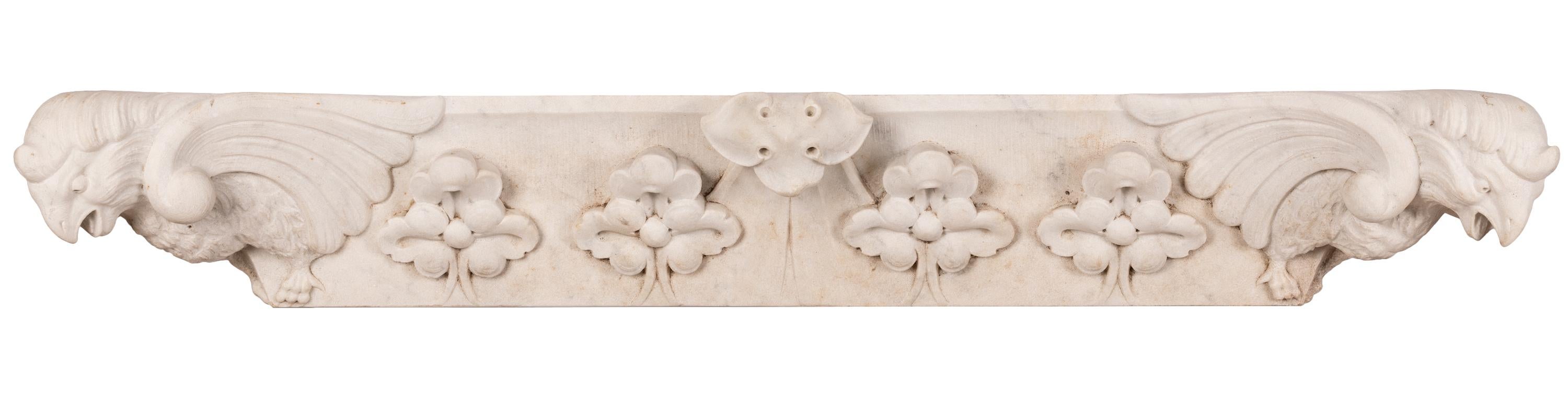 A beautiful hand-carved white marble architectural element, likely a window or door lintel, salvaged from a building renovation project in France. Some motifs hint at the Beaux Arts style, but the expressive birds at either end of the piece are