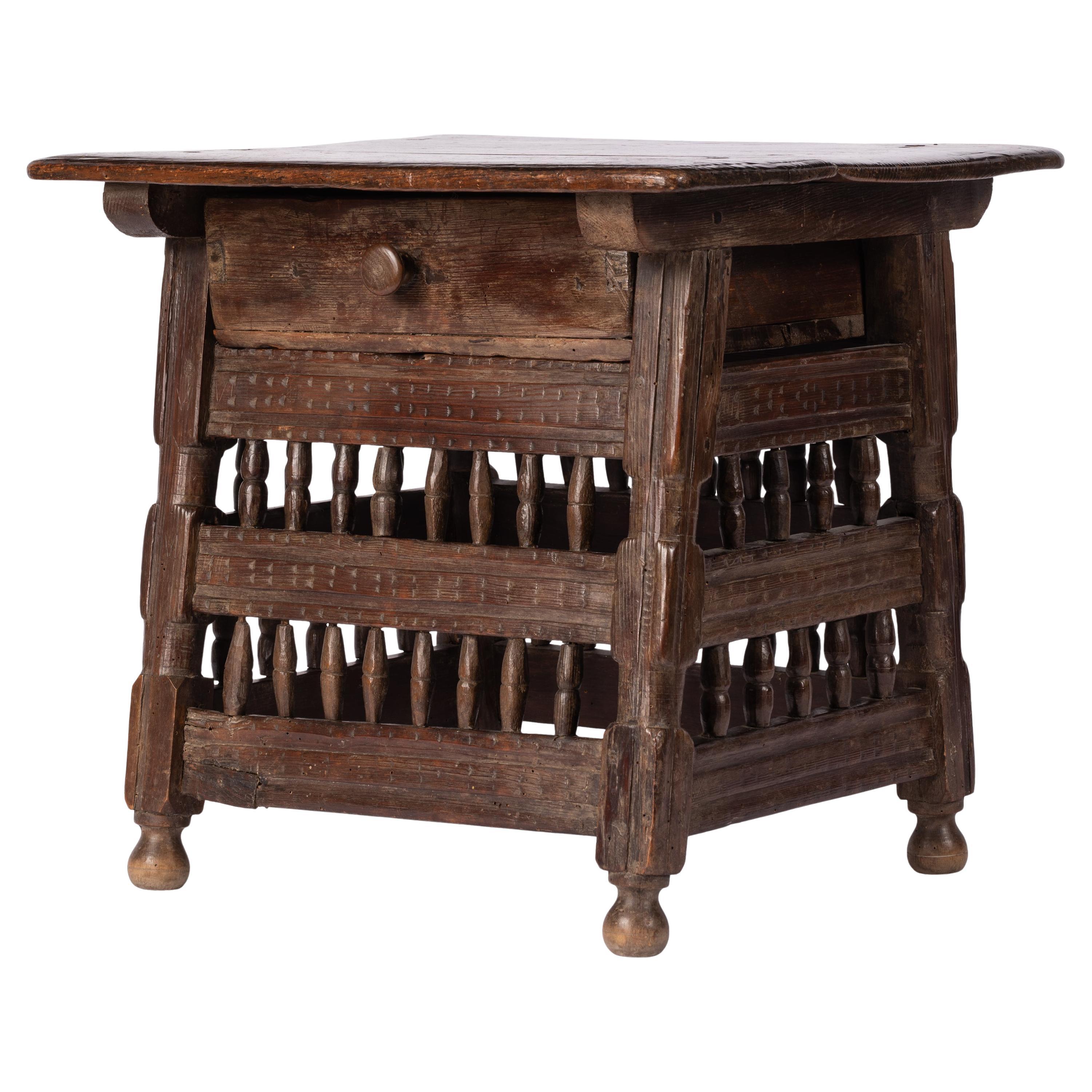 This 18th century rustic side table from the Navarre region of Spain may be small in size, but big in personality. Completely hand-crafted, it is nicely proportioned and its decorative scheme of incised marks and rows of vertical spindles manages to