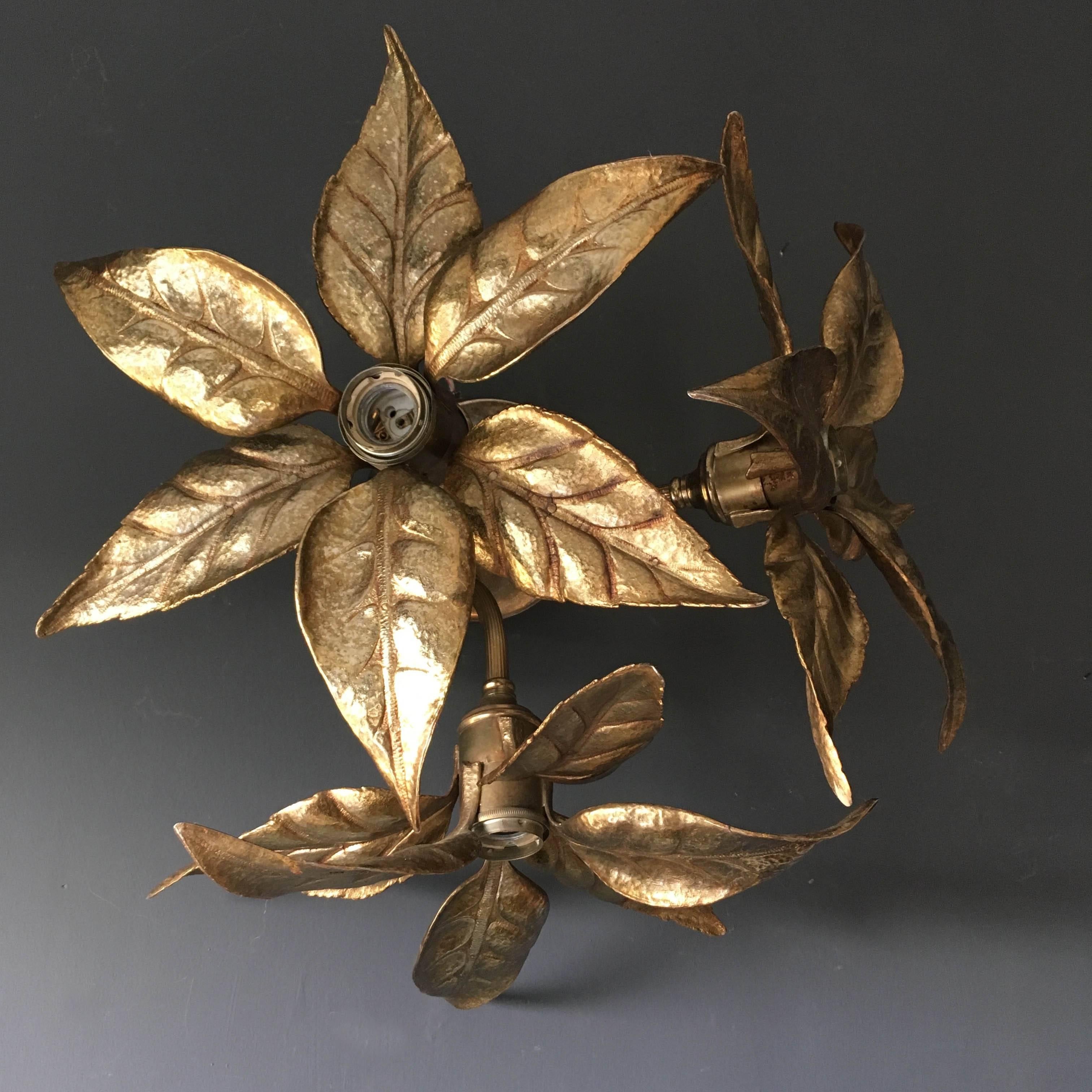 Beautiful large three-flower ceiling light by renowned designed Willy Daro for Massive lighting Co, Belgium, 1970s. 

The three textured leaf like flowers branch out from the centre pendant and hold a single bulb each. The light is solid brass and