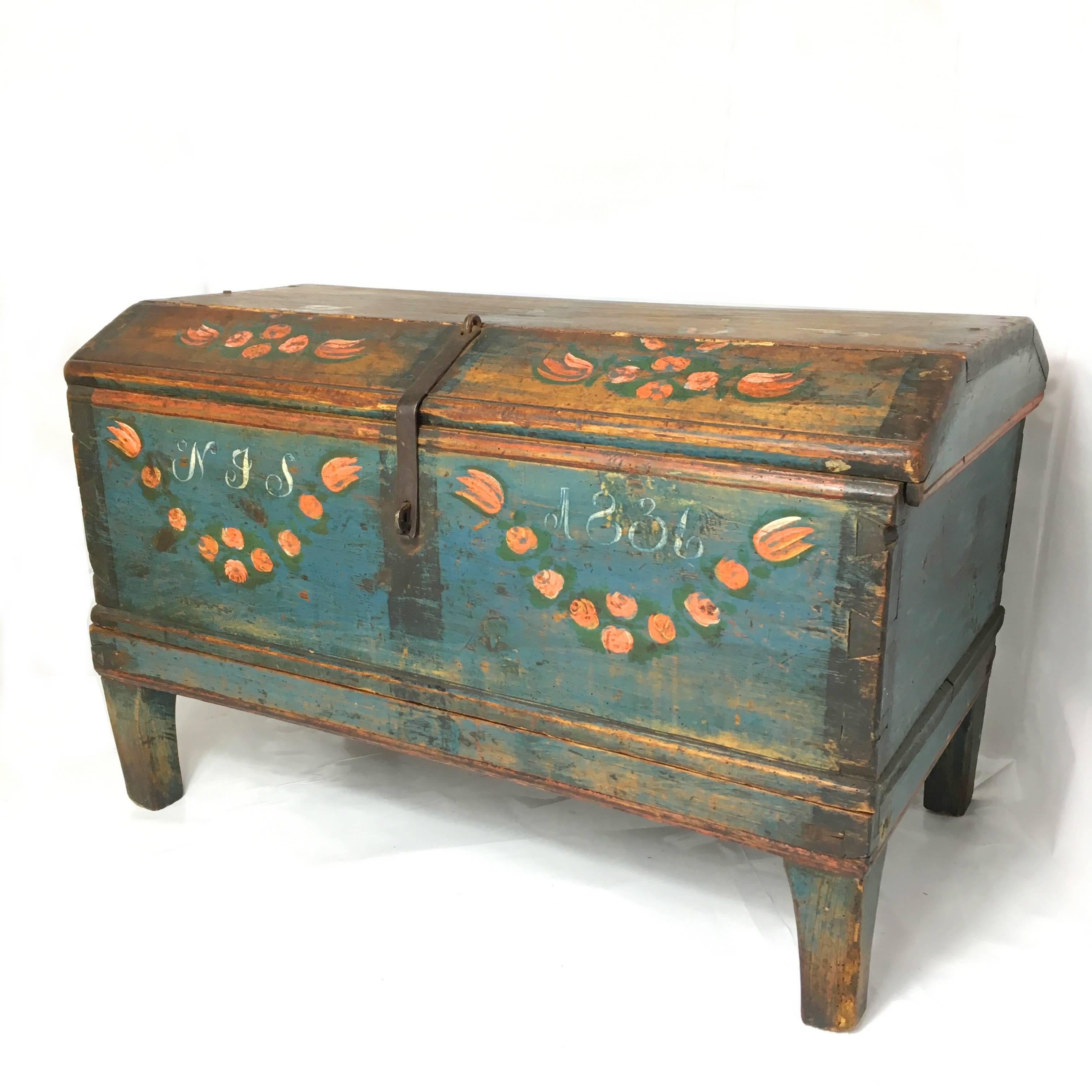 Antique wooden Swedish marriage trunk.

Beautiful hand painted chest on matching stand.

The trunk can be removed from the stand if required.

Dated 1836 and initialed, with all original hinges and metal fastening