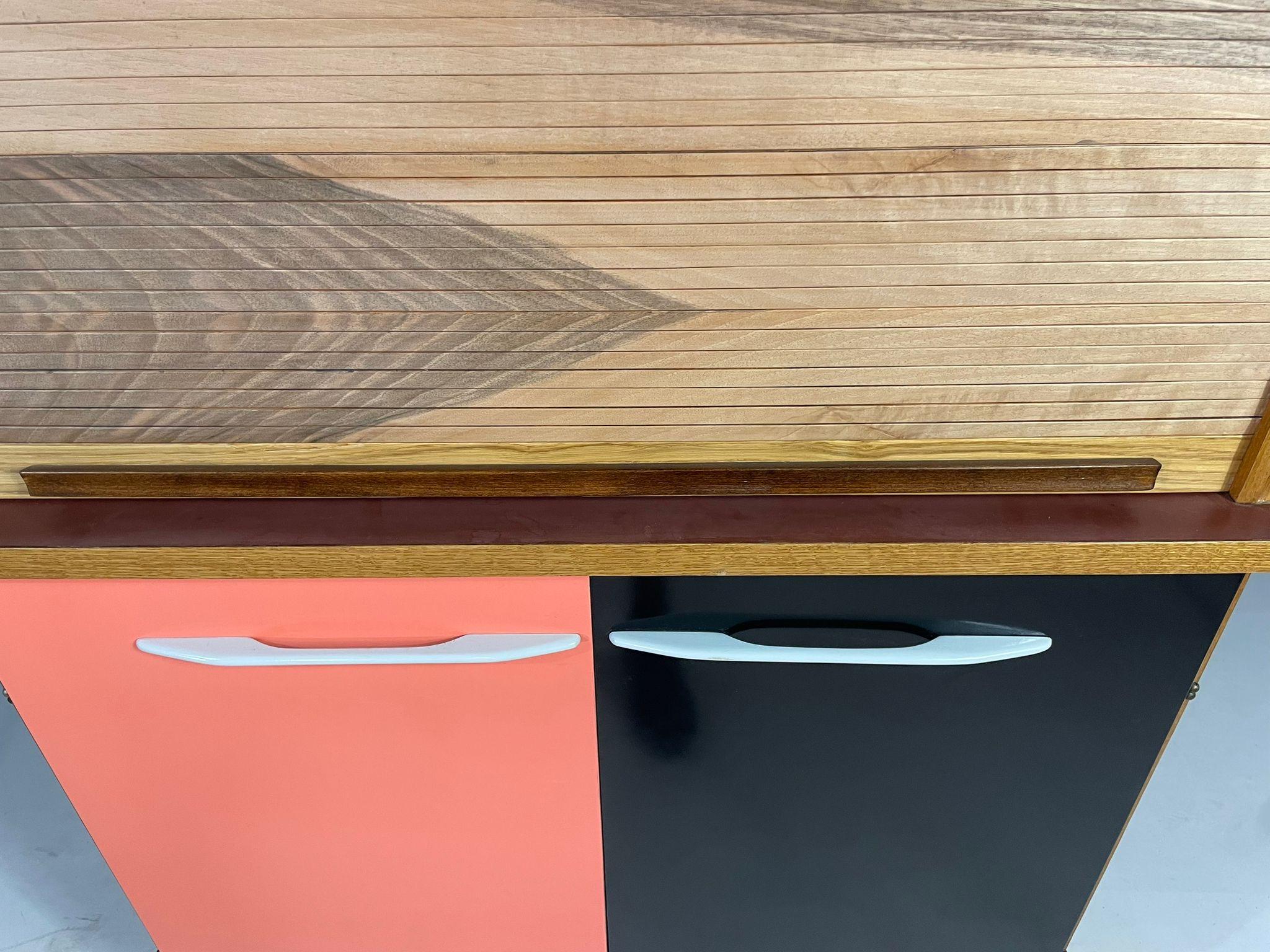 This unique mid-century sideboard with tambour sliding top was produced by Interiér Praha in Czechoslovakia during the 1960s. Its compact and functional design makes it a versatile piece, suitable both as a highboard or serving cabinet.

The upper