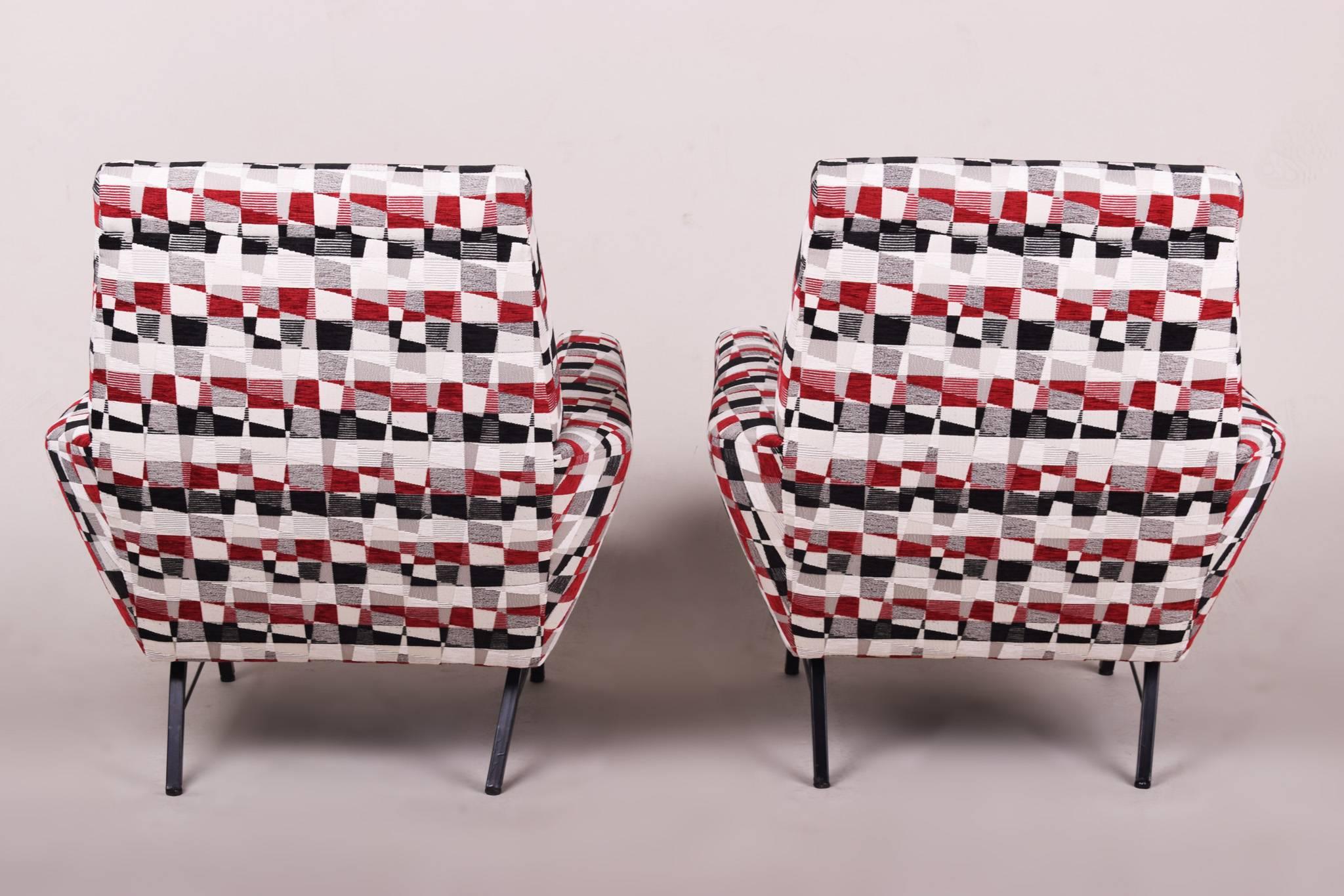 This pair of mid-century Marco Zanuso style lounge armchairs was produced during the 1960s in Italy. The armchairs feature a distinctive shape, black-lacquered steel legs and have all new upholstery. 