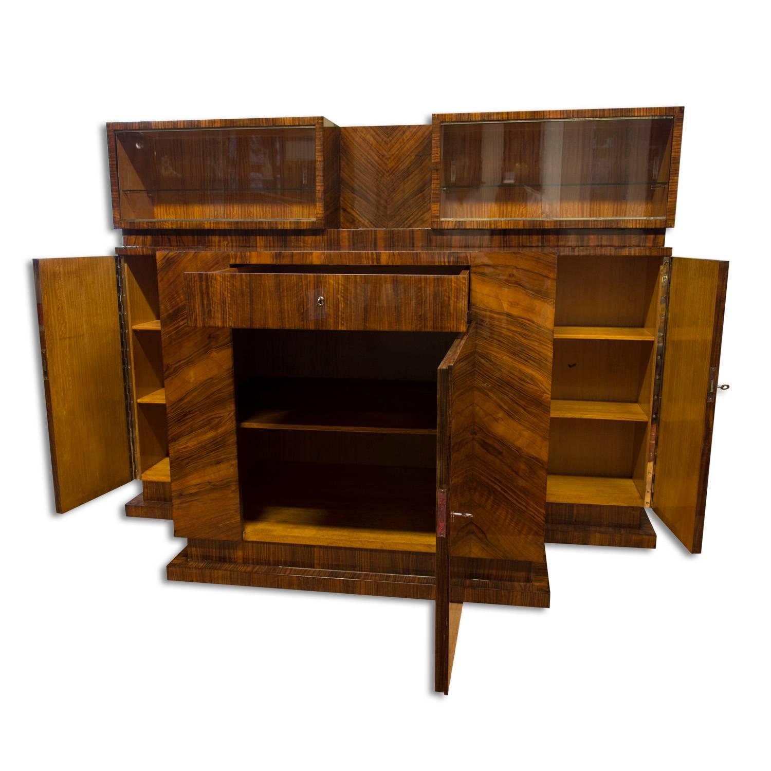 This sideboard from the 1930s was designed by Prague designer Vlastimil Brožek for his own villa. The sideboard is an example for functionalism and is made from wood and veneered walnut. It´s in excellent condition due to a complete renovation with