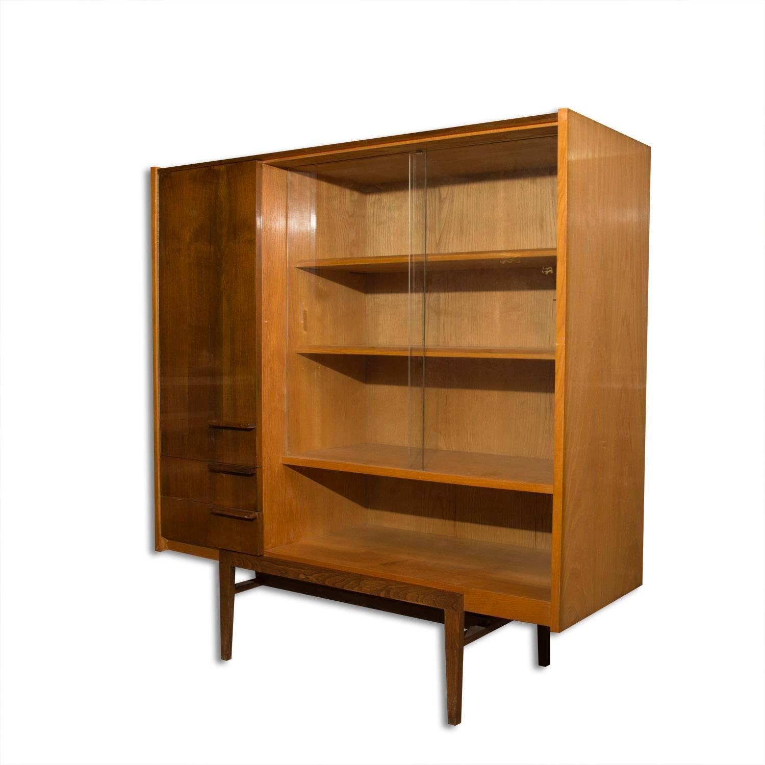 Midcentury Czechoslovak Library cabinet, designed by František Mezulánik and produced by ÚP Závody in the 1960s. Material: wood, plywood, walnut veneer. The cabinet is in its good original condition with minor signs of age and use.