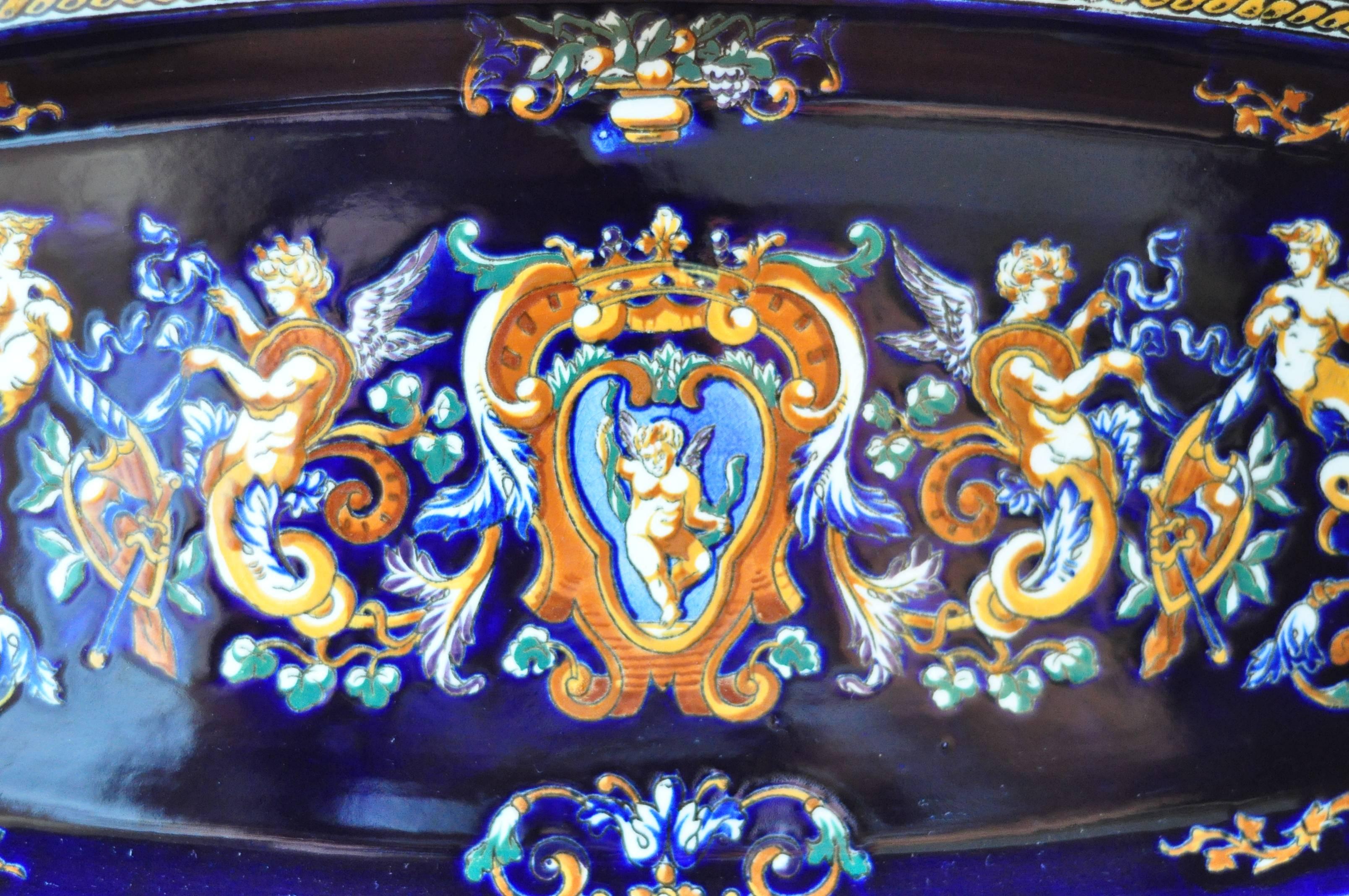 This exquisite and rare, free-form edging, antique Gien Faience Plat a Poisson is made in the 