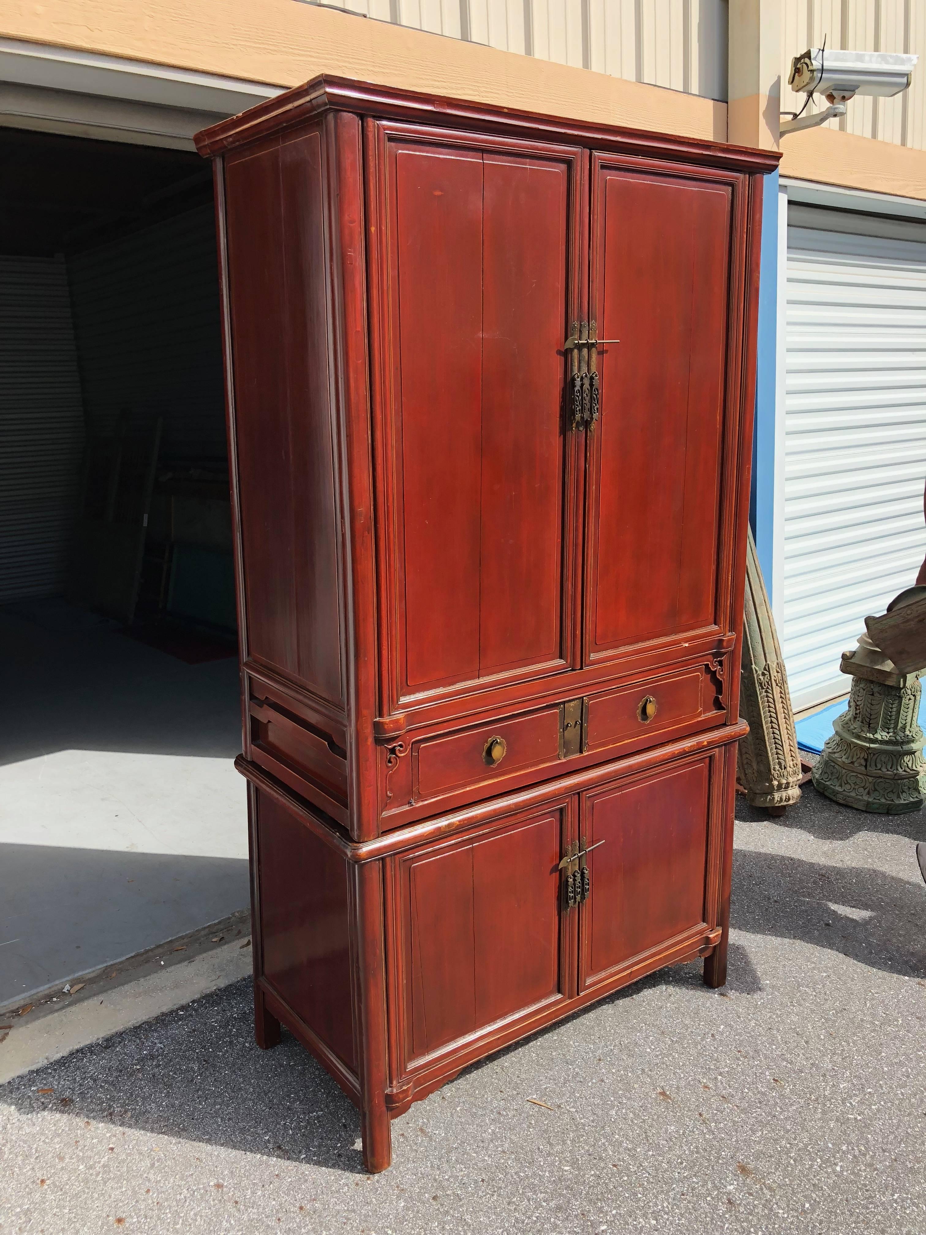 This tall red lacquered Chinese cabinet originates from Zhejiang made of Cypress having five (5) shelves and four (4) drawers made of Cypress wood and red lacquer finish.