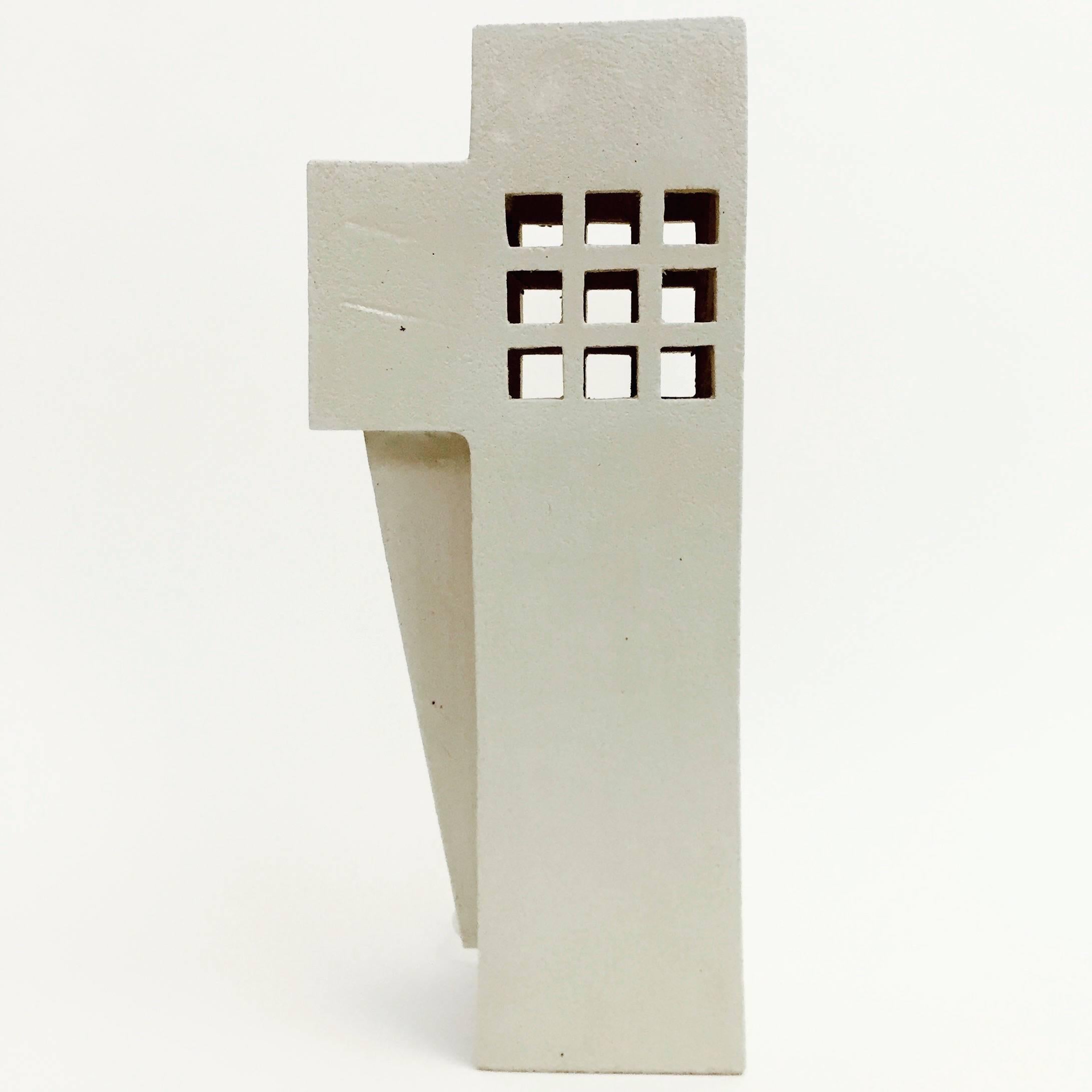 Geometric sculpture, forming a column lamp base, textured clay glazed in shades of pale cream, decorated with open windows perforations.
One of a kind contemporary handmade creation, designed by the French ceramicist.

Note to International