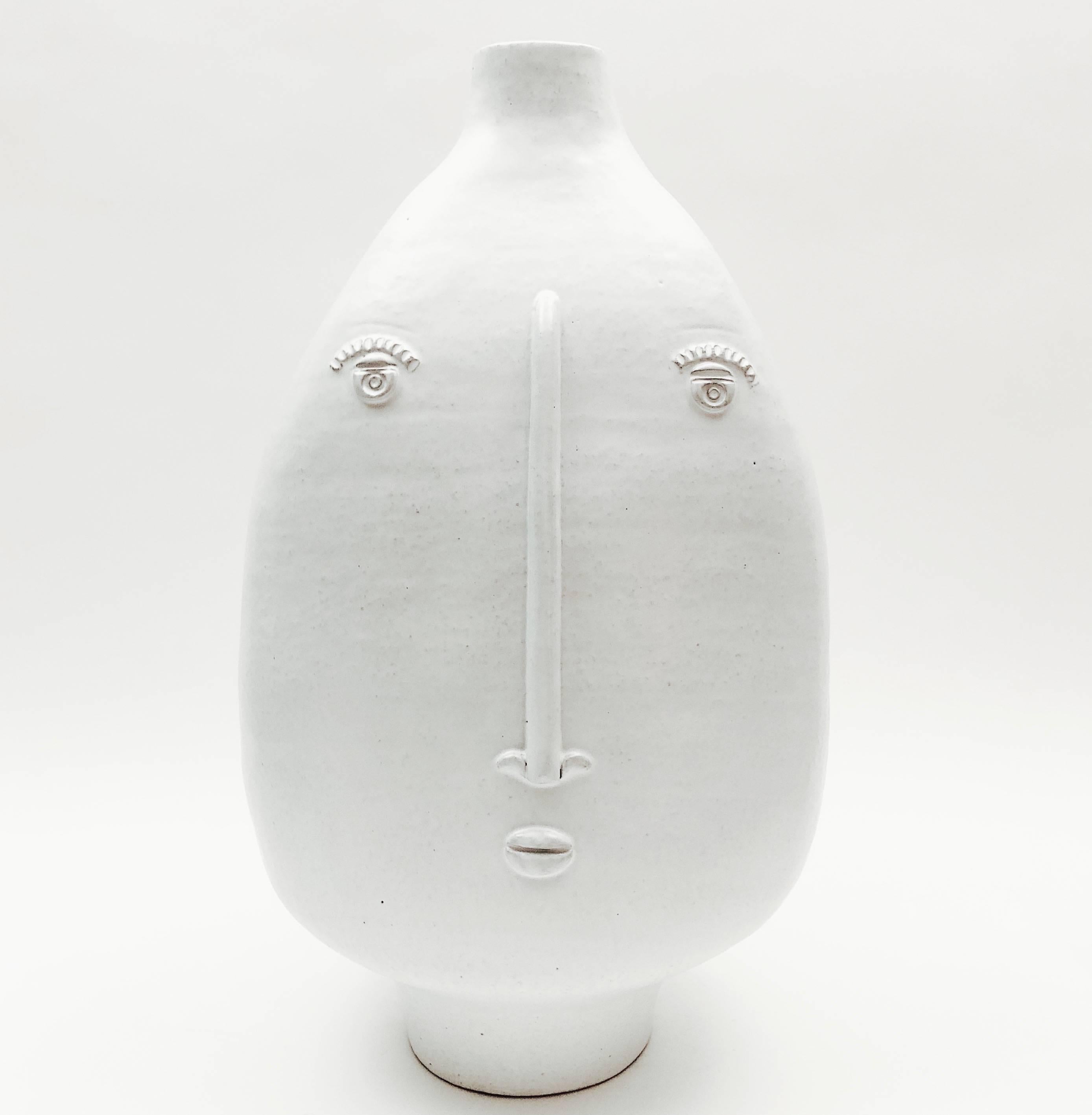 Large sculptural and organic ceramic piece forming lamp-base, textured stoneware glazed in milky white, and decorated with two stylized visages front and back. 
One of a kind handmade piece signed by the French ceramicists, DaLo. 

Height