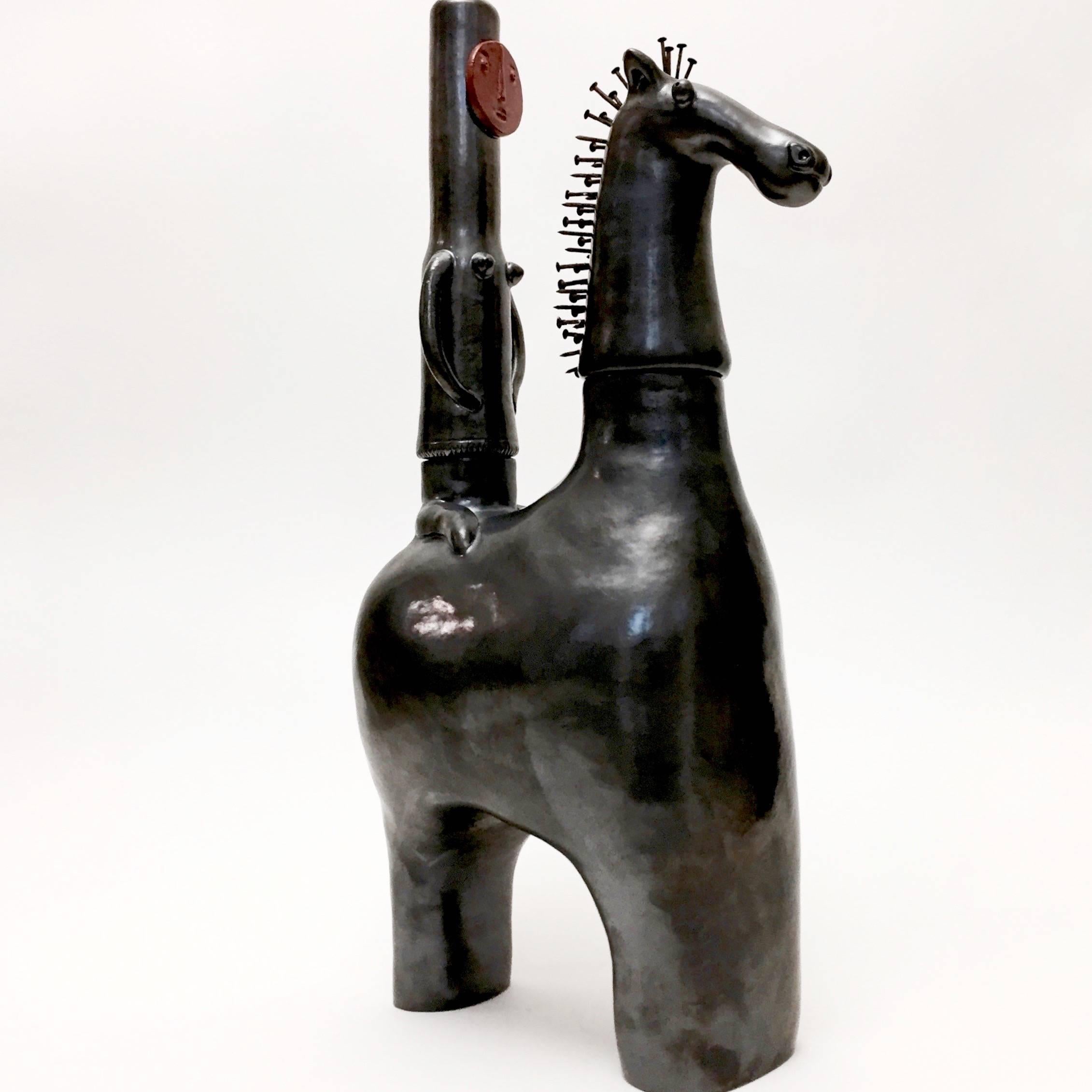 Important sculpture forming a stylized equestrian group, earthenware glazed in glossy black and dark red, the horse mane is decorated with metal nails.
One of a kind hand-sculpted piece, designed by the French ceramicists, Dalo. 

The removable
