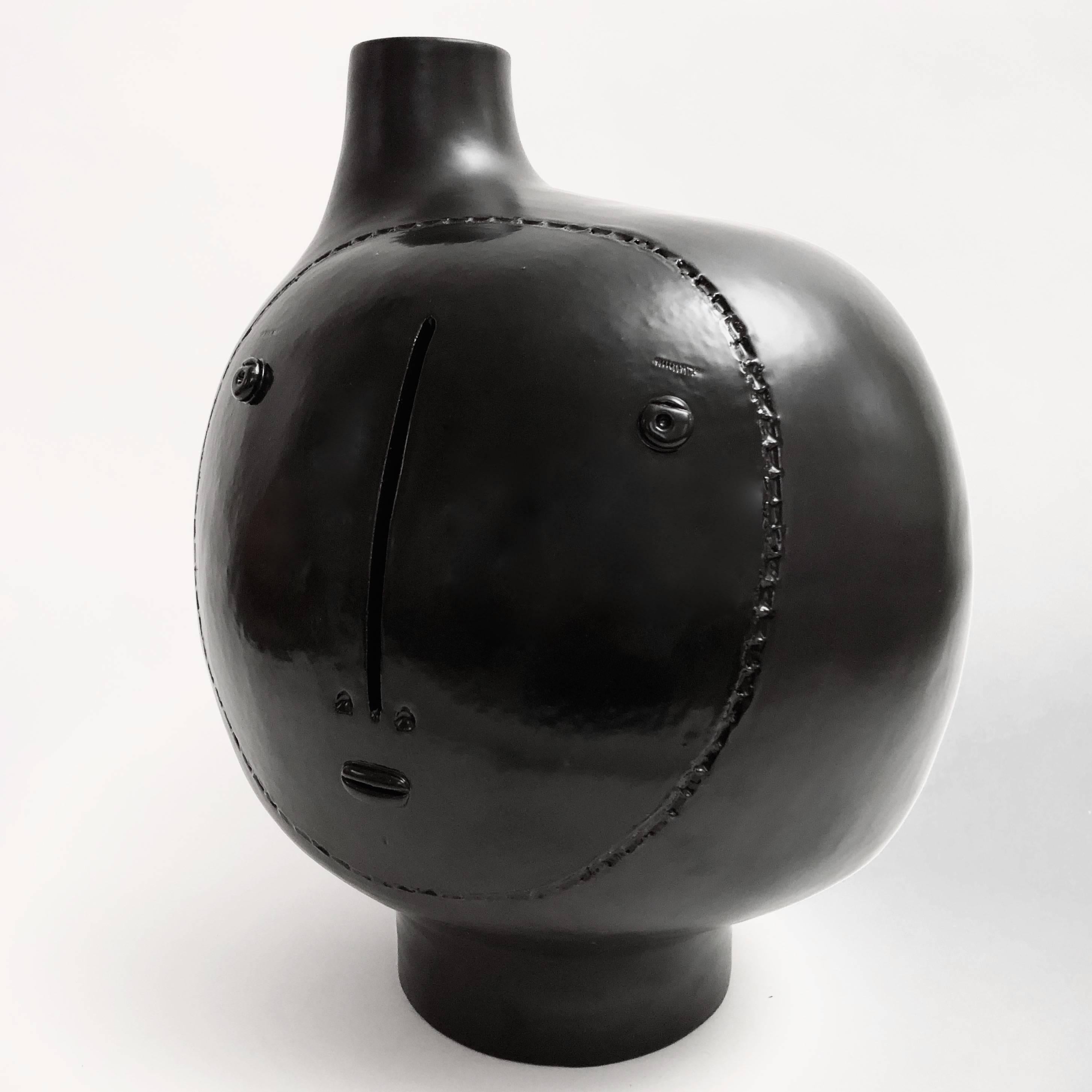 Large hand-sculpted ceramic lamp base, biomorphic shape, stoneware glazed in matt and shiny black, decorated with a stylized visage in front.

One of a kind piece designed and signed by the French ceramicists. 

The height dimension is for the