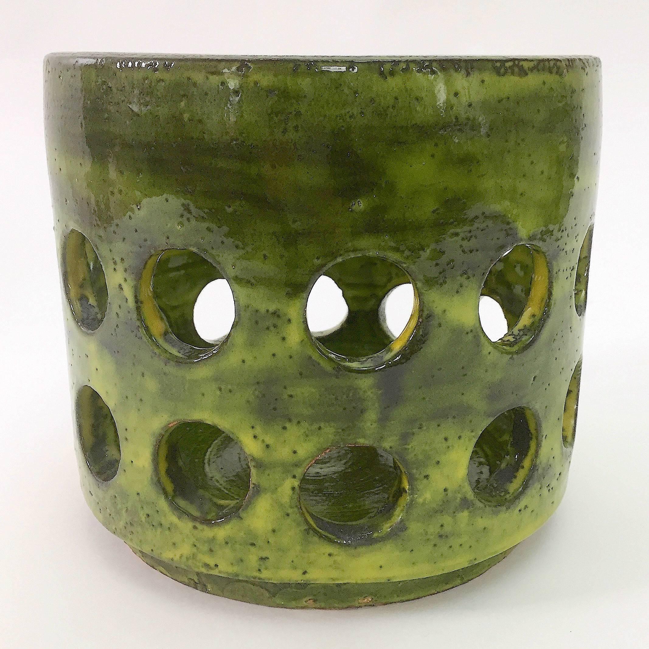 Important cylinder vase or cachepot, ceramic glazed in shades of shiny green, and decorated with perforated geometric circles.

Rare artwork designed by the artist from the collection named Engrenages.
This piece is unsigned but referenced in the