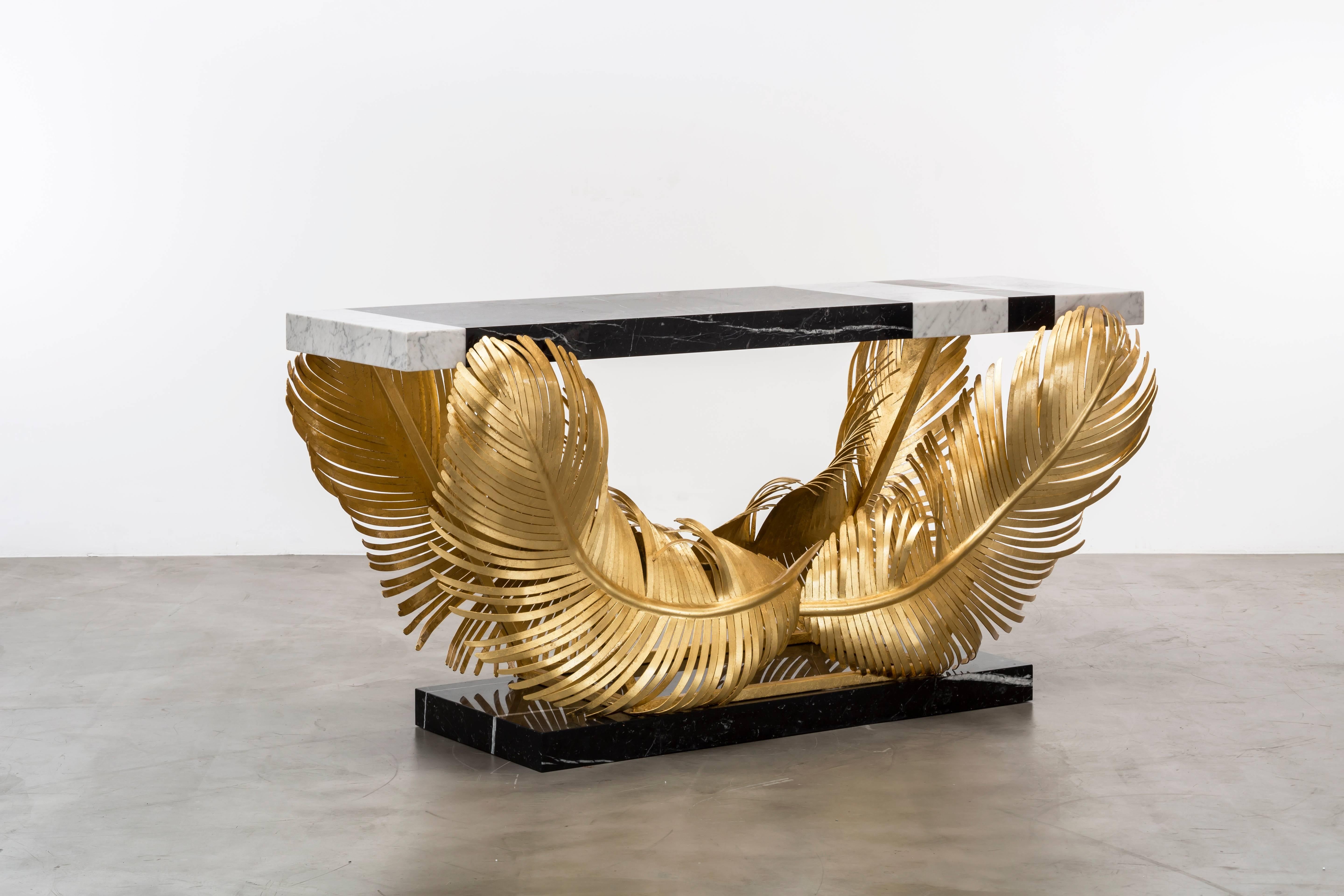 JOSETTE CONSOLE - Modern Gold Leafed and Marble Console

The Josette Console table is a stunning and unique piece of furniture that is sure to make a statement in any room. Hand-forged with gold leaf over iron, this console table features sculptural