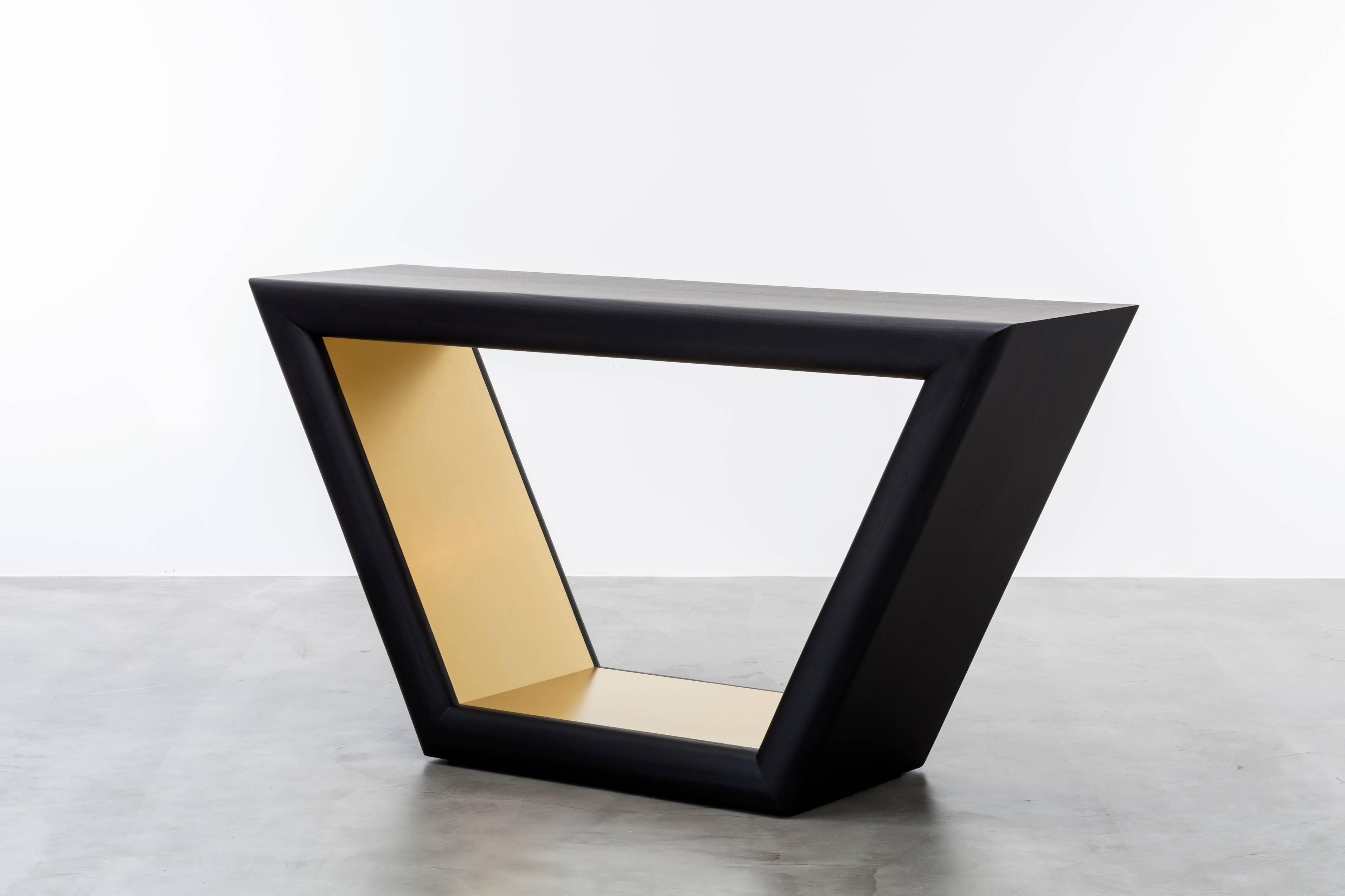 JOLIE CONSOLE - Modern Ebony Oak Console with Brass Metal Inlay

The Jolie console table is a modern and stylish piece of furniture that draws inspiration from the jewelry of the 1960s. This console table features a hand-carved bull nose detail with