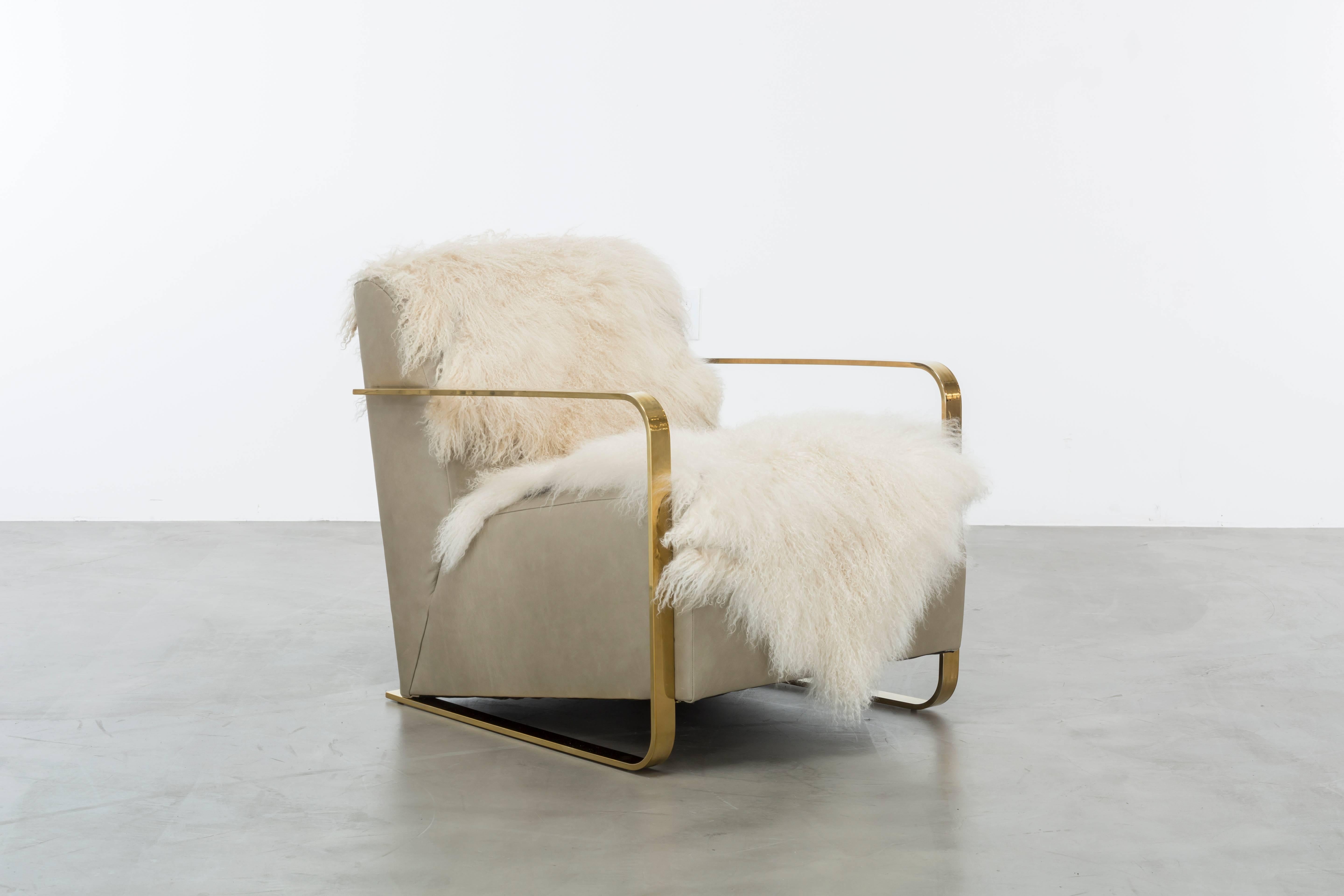 The Cosette Chair features a tightly upholstered leather seat and back with attached live edge Tibetan Mongolian Lamb fur.  Polished brass or nickel arms are the perfect glamorous touch.  Fully custom and made to order in California.  As shown in
