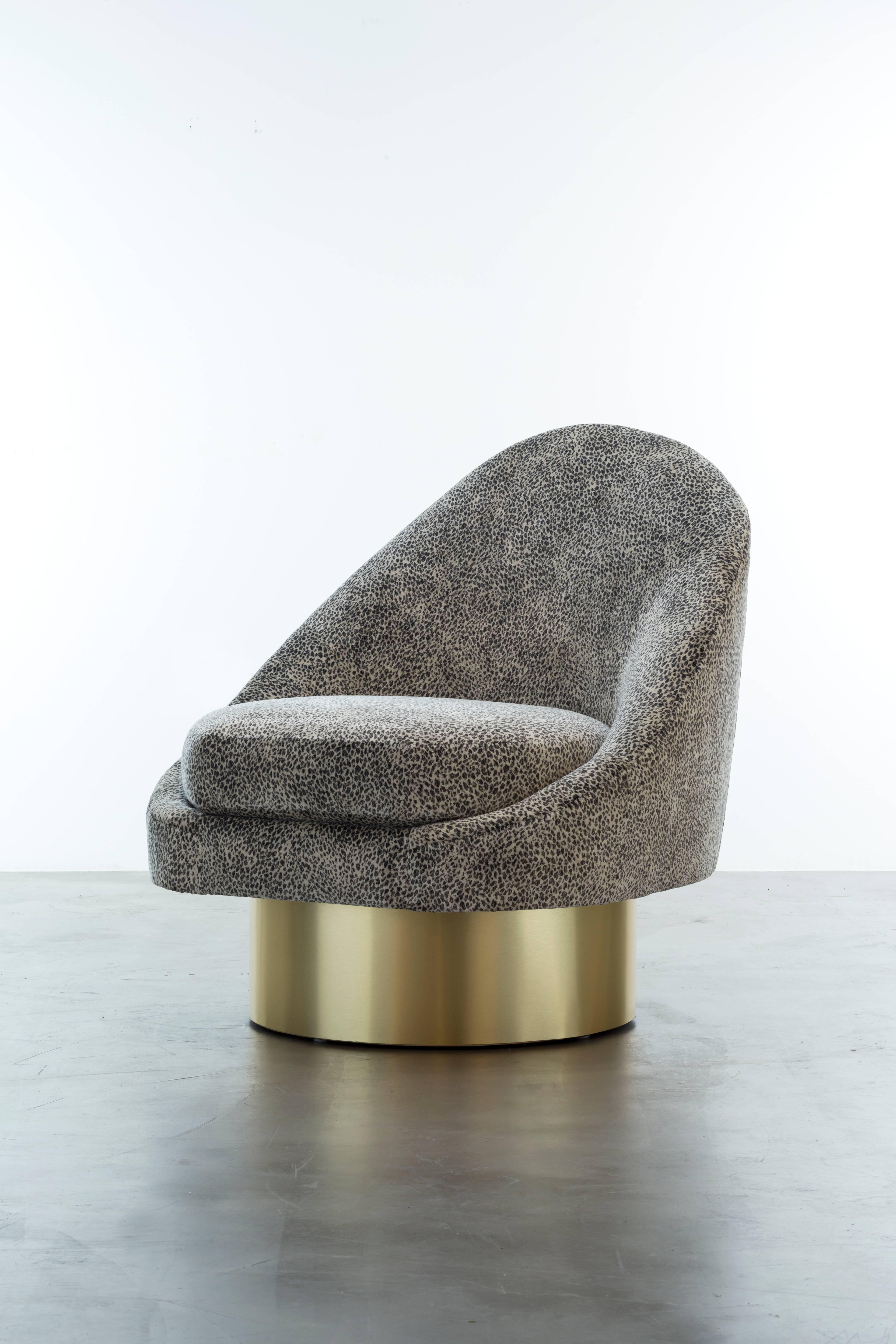 The Sandrine Swivel Chair inspired by the curvature of Gaudi architecture features an asymmetrical sophisticated velvet slope that meets a swivel plinth base to make a minimal and elegant statement.  Fully custom and made to order in California. As