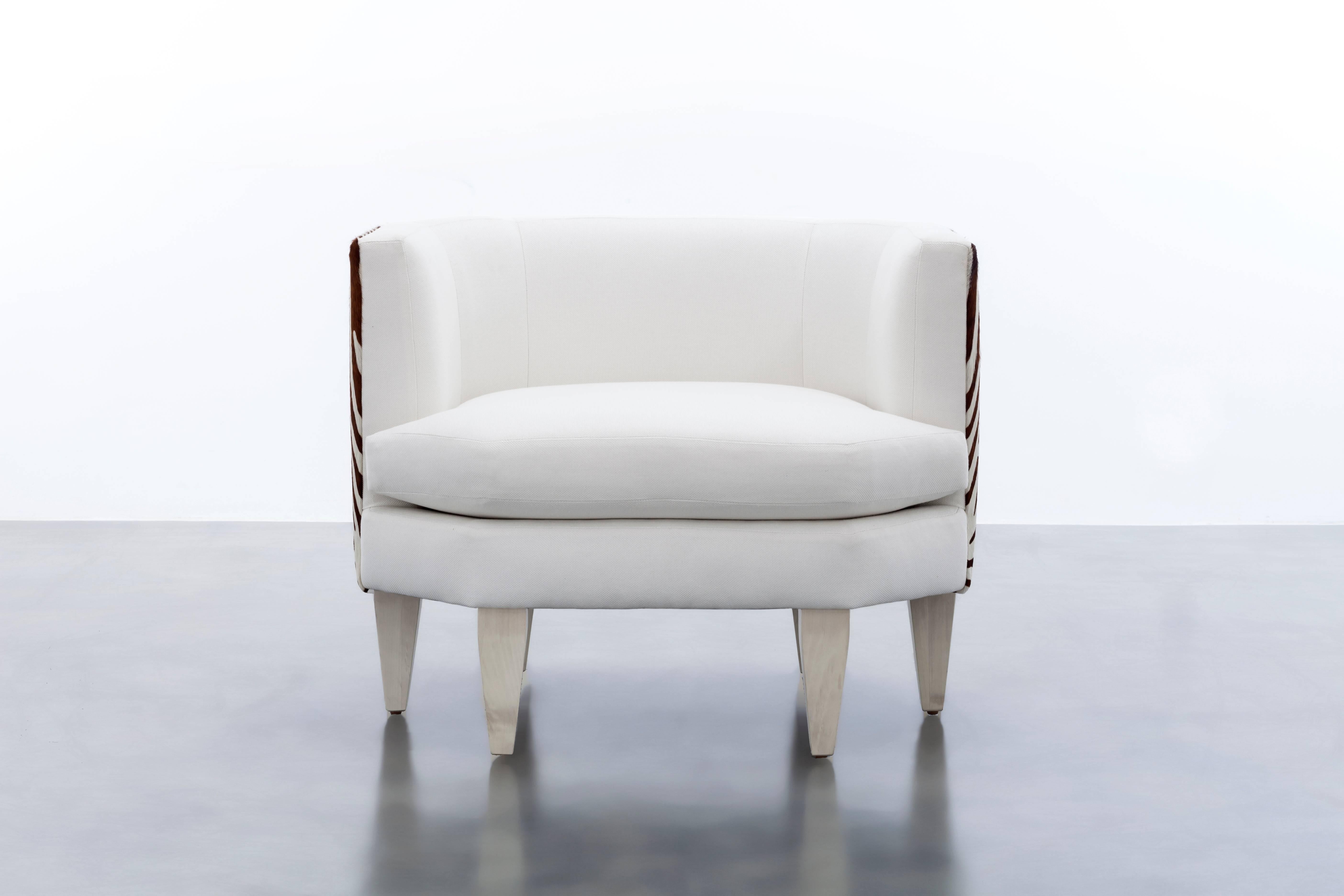 The Odette Chair features an octagonal shaped upholstered seat and back with contrast hair on hide back panels floating upon six wood legs.  Fully custom and made to order in California.  As shown in Bamboo White and Contrast Hair on Hide $6,475.00.