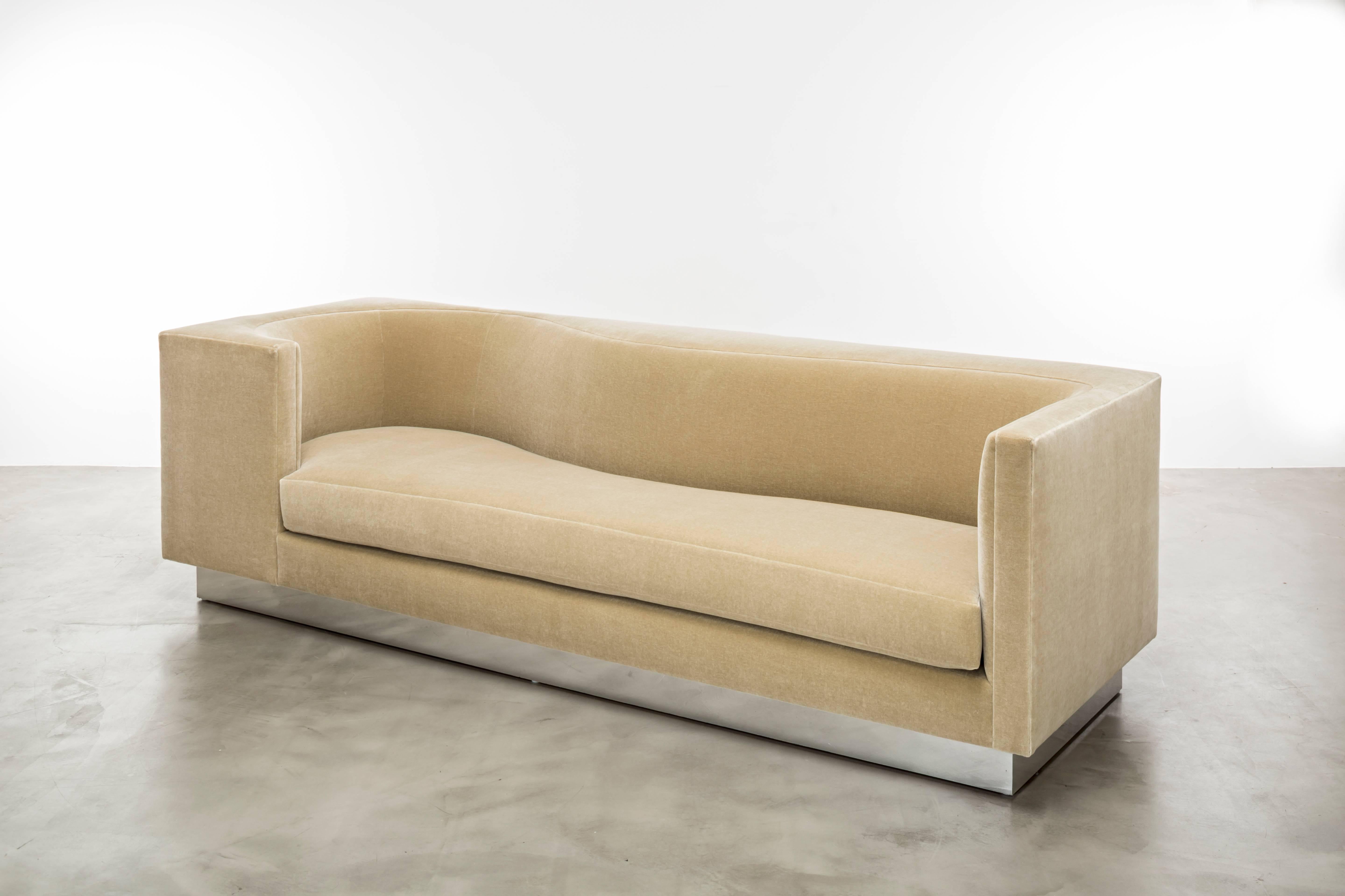 The Laurent Sofa is a luxurious and modern piece of furniture that is both stylish and comfortable. This asymmetrical sofa features a minimal modern rectangular frame with contained curves in its architecture, giving it a unique and eye-catching