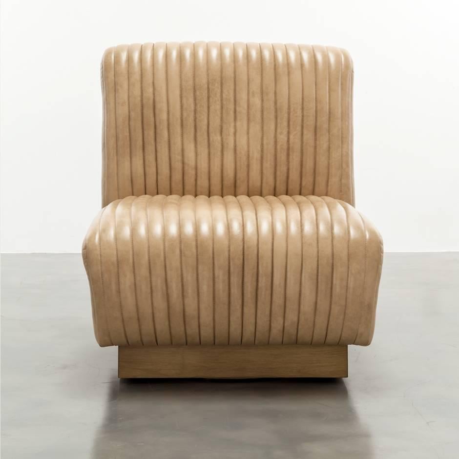 The Channel Chair inspired by vintage car interiors features channeled waterfall leather on a wood swivel plinth base.   Fully custom and made to order in California (Swivel option available.) As shown in Leather $5,970. 
Starting at $3,930.