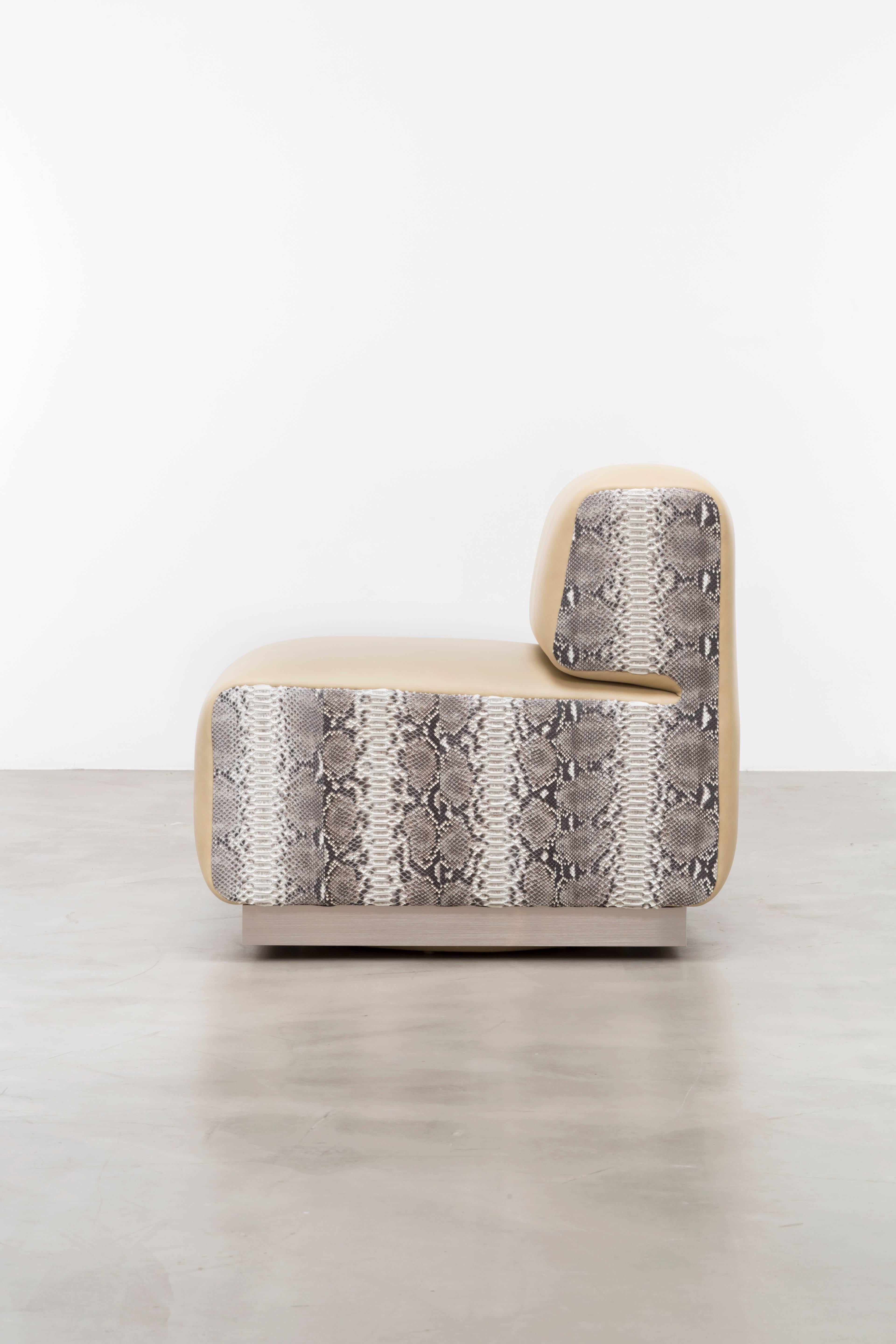 The Leger Chair is a piece of furniture that draws inspiration from the vintage python skin handbags of the 1970s, creating a unique and luxurious seating option. This chair is proudly made in the USA and offers extensive customization to meet your