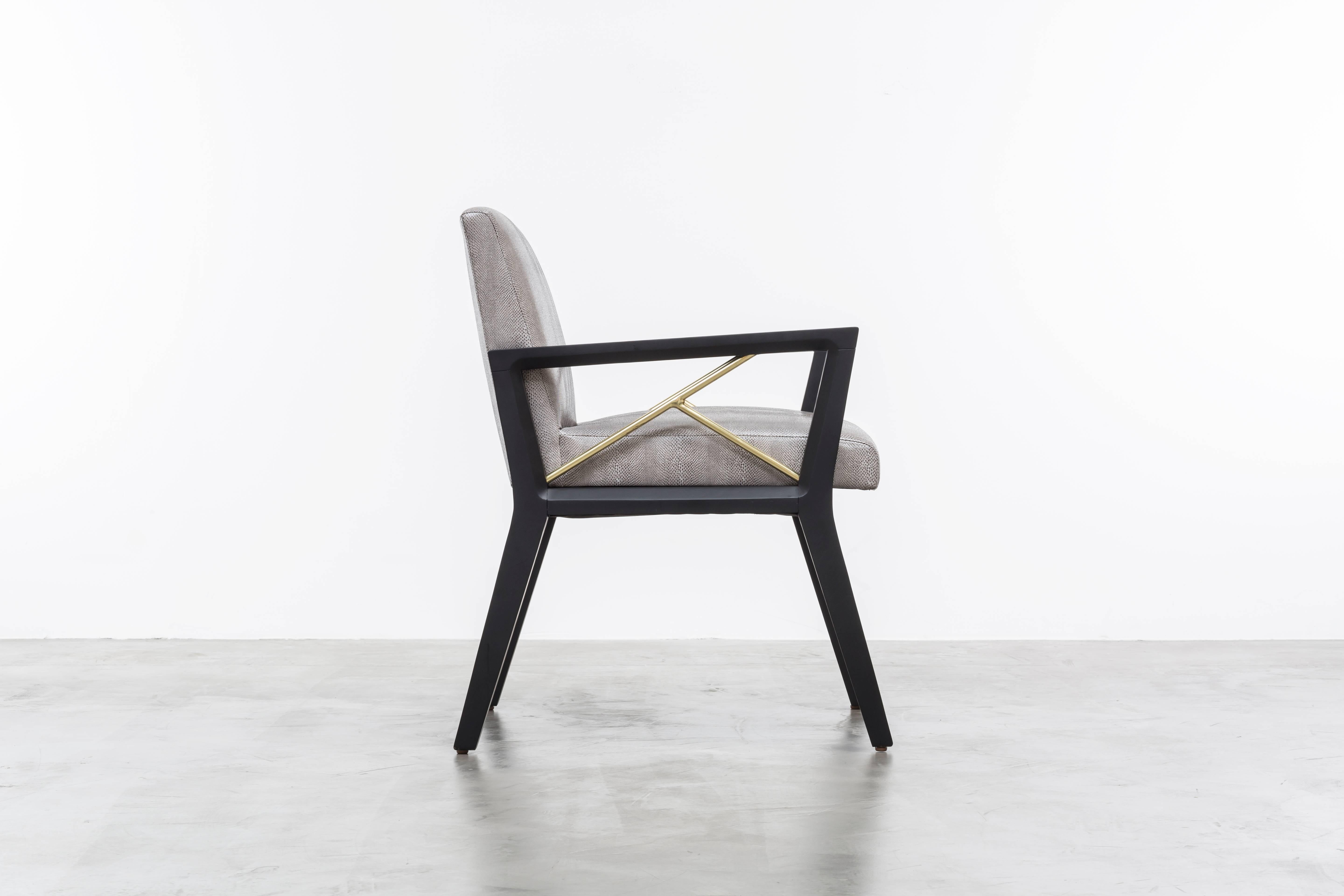 The Andre Chair is a modern side or dining chair featuring a wood frame with a fractured brass pole detail.  Fully custom and made to order in California.  As shown in Snake Vinyl $4,450  Starting at $4,200.