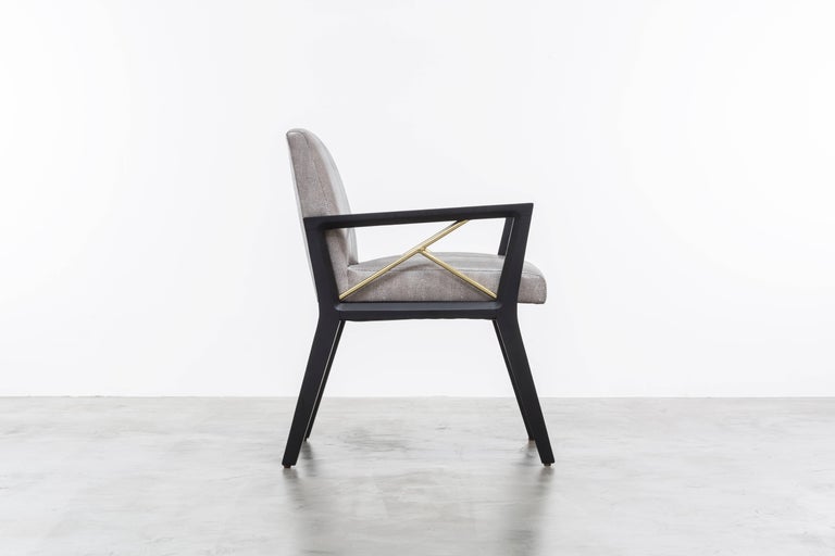 The Andre Chair is a modern side or dining chair featuring a wood frame with a fractured brass pole detail.  Fully custom and made to order in California.  As shown in Snake Vinyl $4,450  Starting at $4,200.