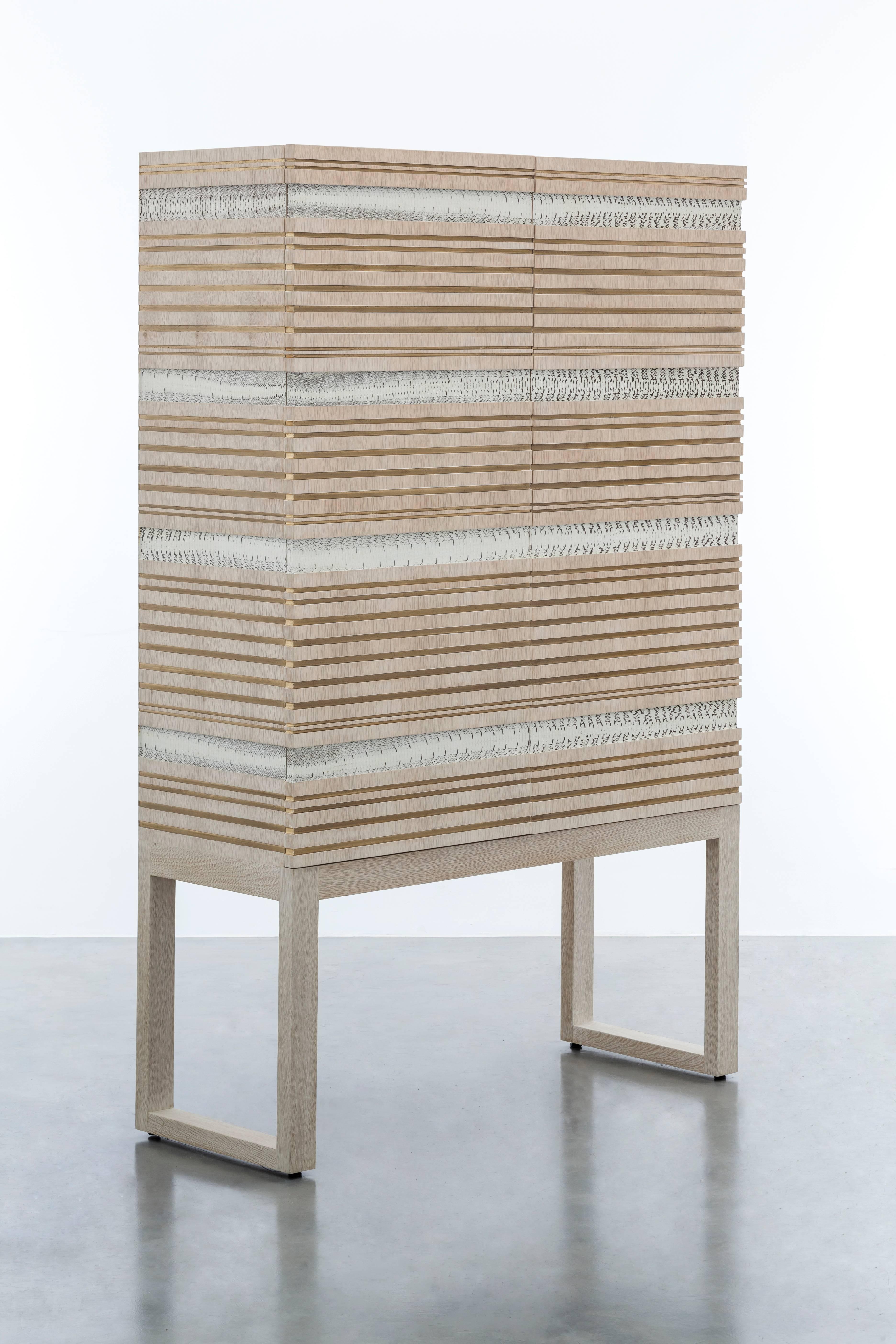 SIMONE CABINET - Modern Oak Armoire with Authentic Snakeskin

The Simone Cabinet is a modern and stylish armoire that is sure to make a statement in any room. It features a bleached white oak body with gold leaf and authentic python snakeskin