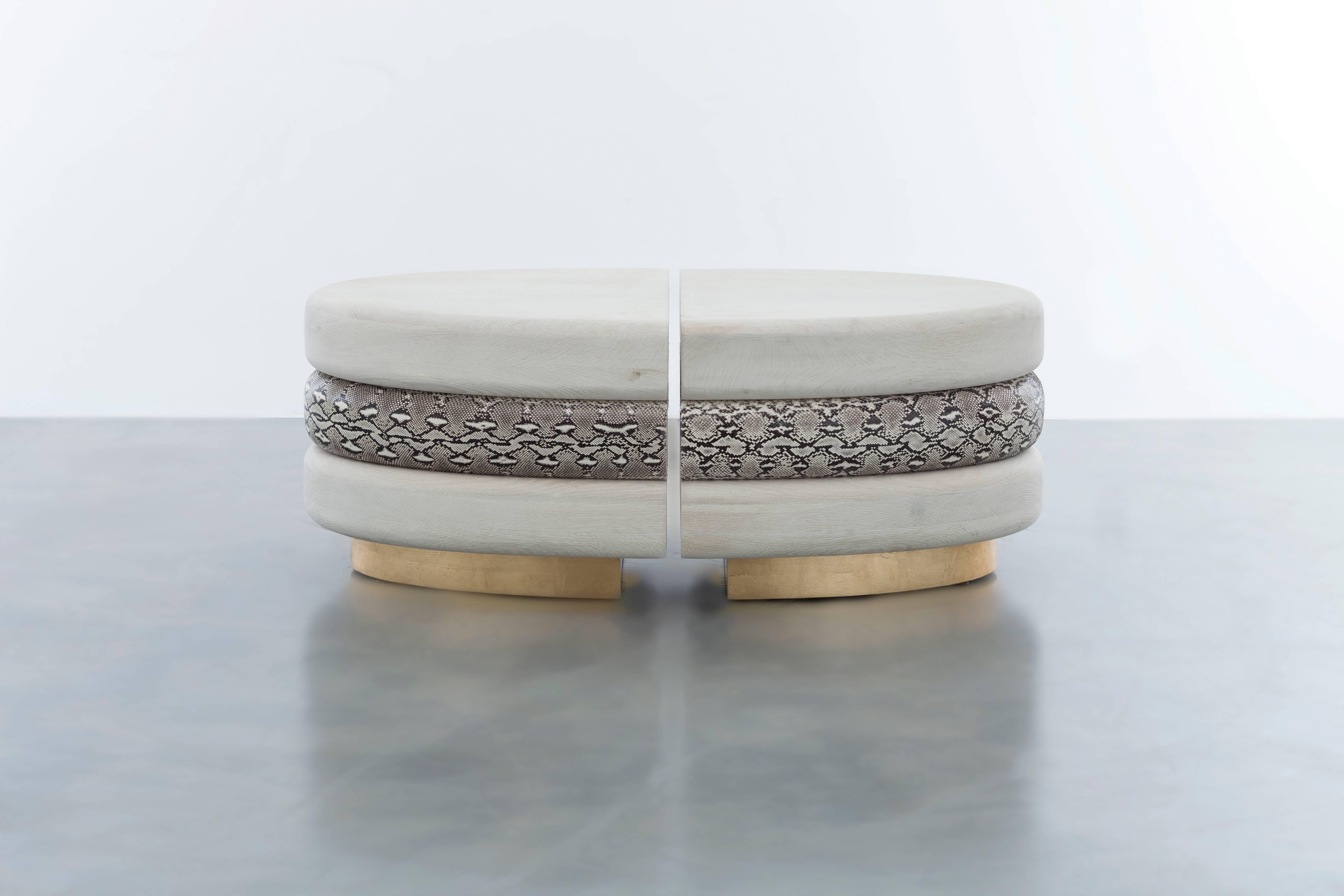 CELINE COFFEE TABLE - Modern Bleached Oak with Real Python Skin and a Gold Base 

The Celine coffee table is a truly unique and luxurious piece of furniture that features layers of hand-carved bullnose white oak and real python skin floating above a