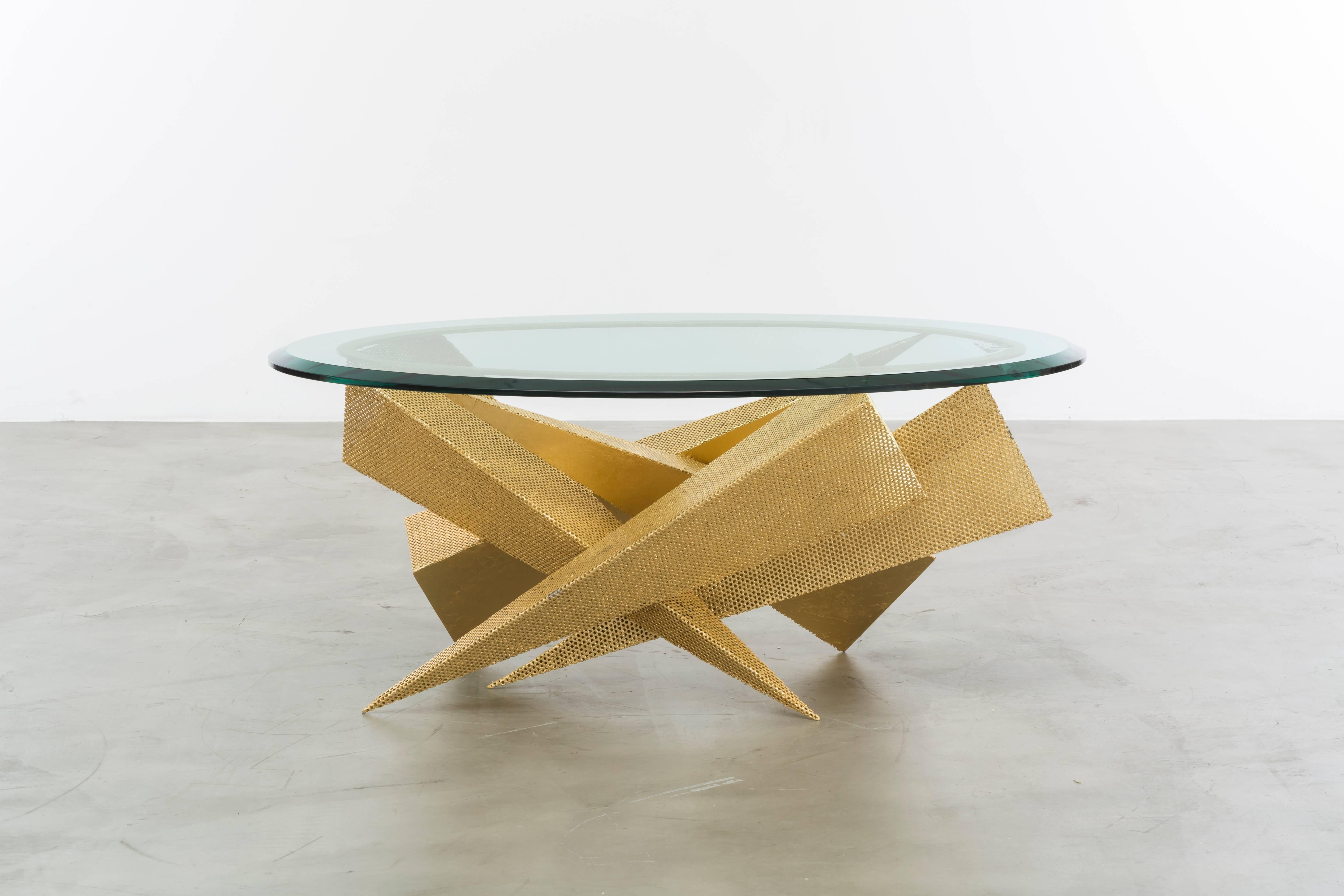 The Trystan coffee table is a modern sculptural gold leaf cocktail table made of gold leaf over perforated iron with beveled edge glass. Fully custom and made to order in California.