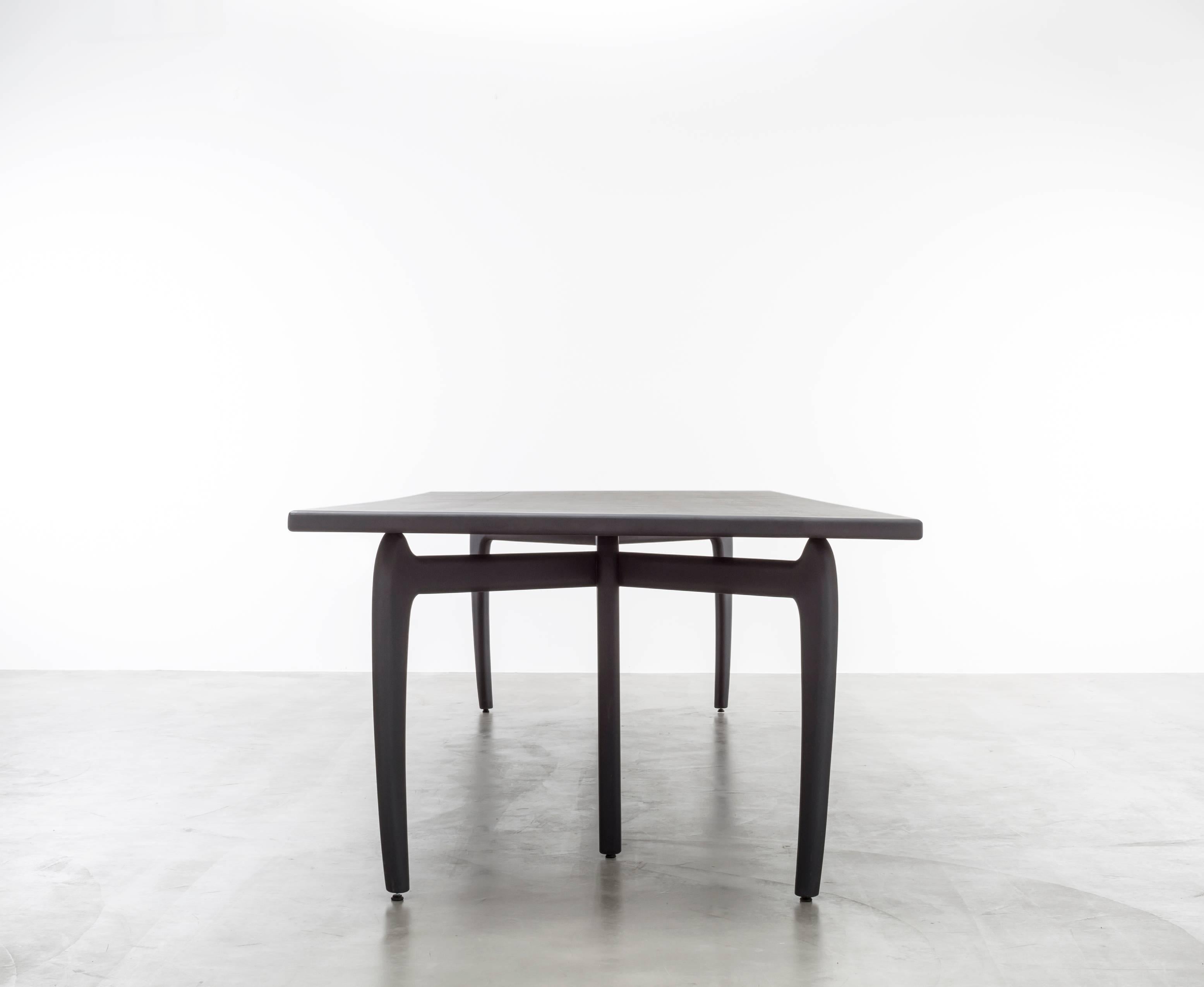 THEO DINING TABLE - Modern Hand-Carved Ebony Wood Dining Table

The Theo Dining Table is a beautiful and modern piece of furniture that combines a mid-century sensibility with contemporary design elements. It is made to order in California and fully