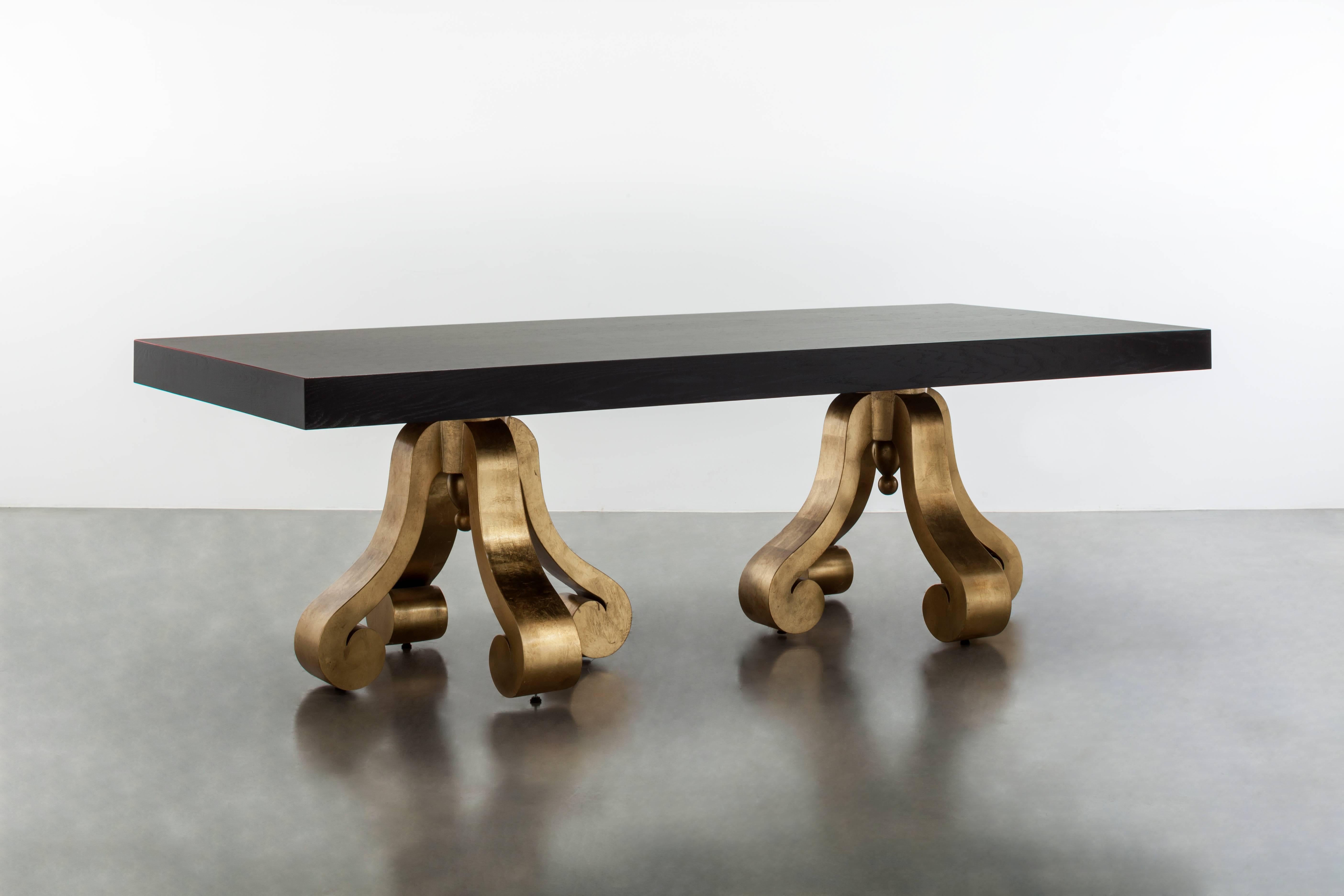 The Lille dining table is a modern dining table featuring two gold leaf pedestals suspending an ebony oak top. Fully custom and made to order in California. As shown in ebony oak $17,325.00. Starting at $14,015.00.