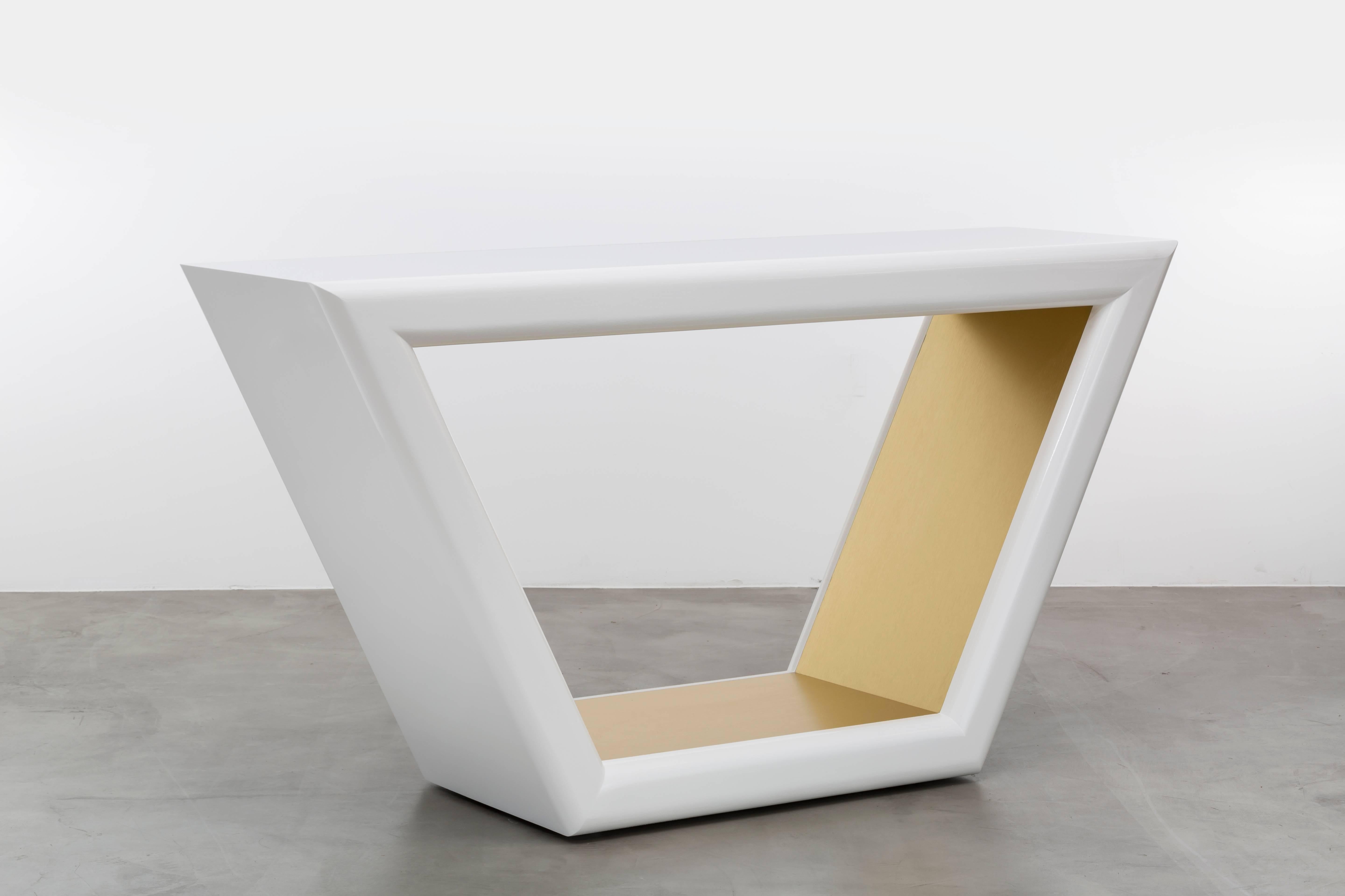 JOLIE CONSOLE TABLE - Modern  White Lacquer Console and Gold Metal Inlay

The Jolie Console Table is a stunning piece of furniture that draws inspiration from the elegant and intricate jewelry of the 1960s. It features a hand-carved bull nose detail