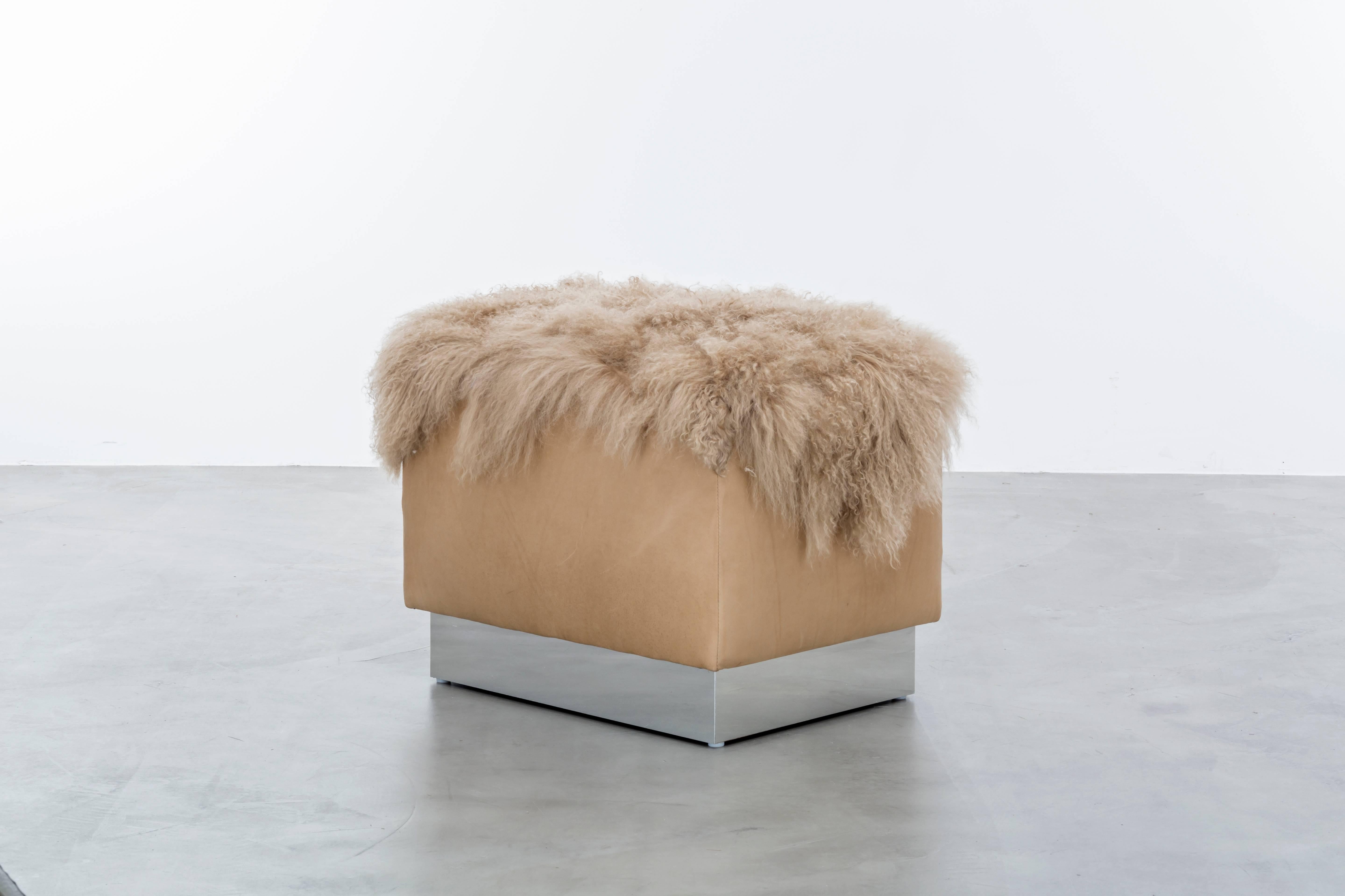 COSETTE OTTOMAN - Modern Leather Ottoman with Tibetan Mongolian Lamb Fur Pelt

The Cosette Ottoman is a one-of-a-kind piece that combines luxurious leather and Tibetan Mongolian lamb fur to create a stunning and comfortable seating option. Its