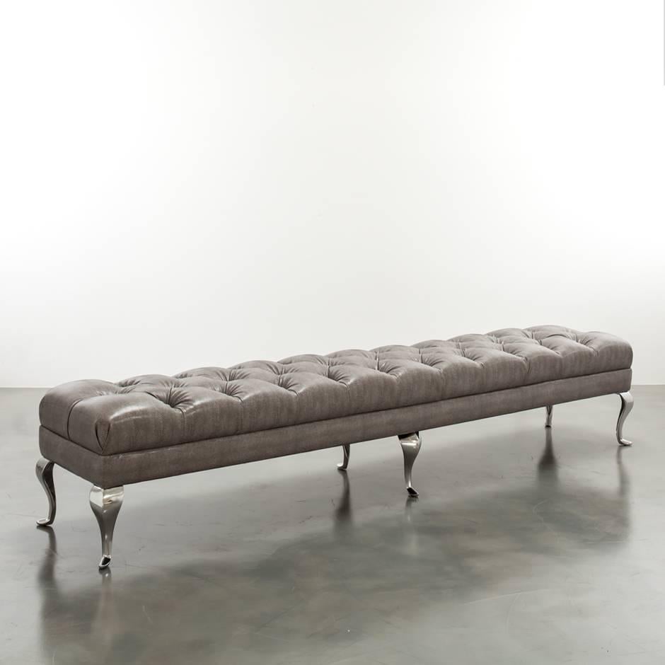 The Colette bench features a modern tufted tightly upholstered frame upon six metal legs. Fully custom and made to order in California. As shown in snake vinyl in grey $4,330. Starting at $3,680.