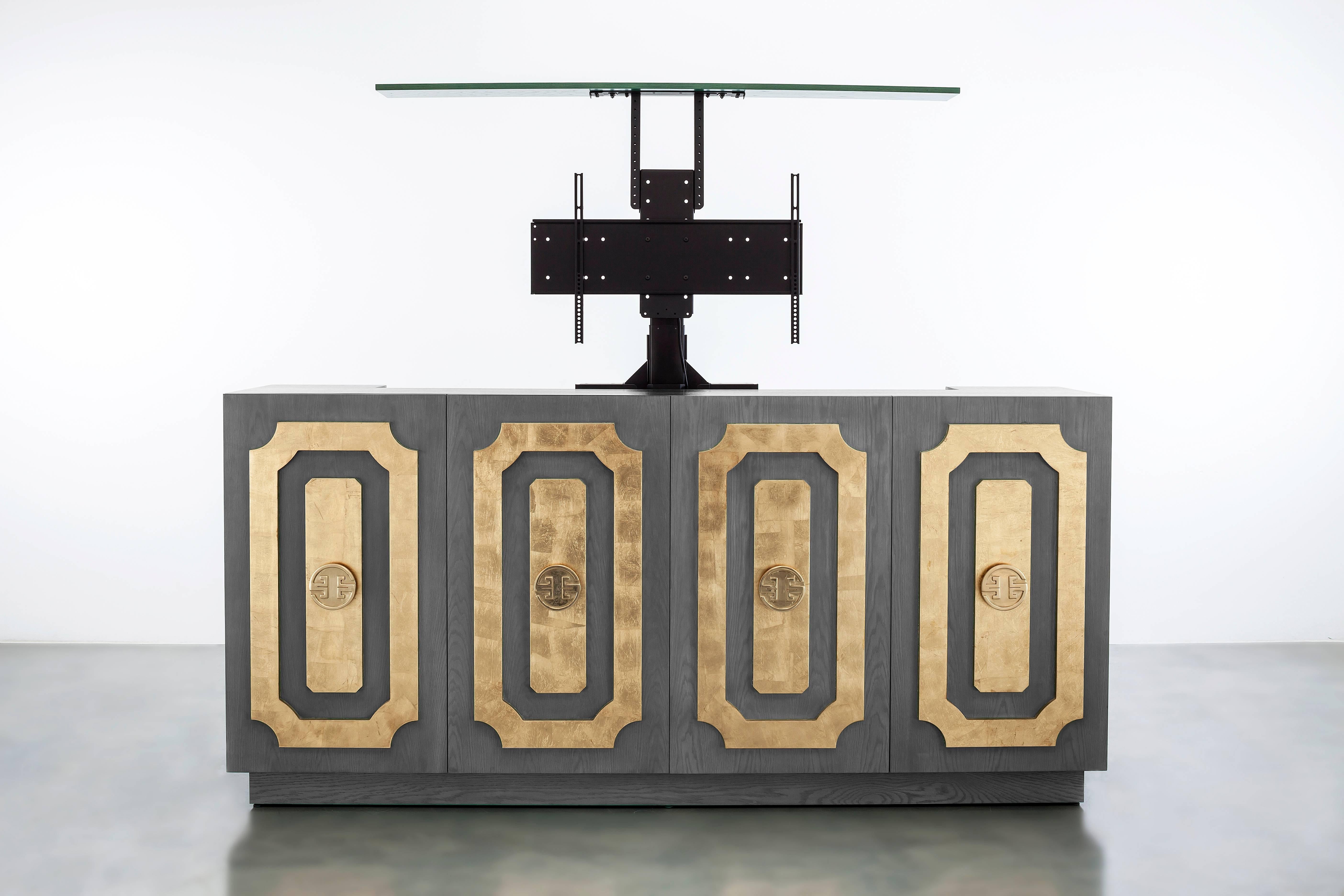 The Dauphine Media Cabinet features an oak and gold leaf design with an integrated tv lift. Fully custom and made to order in California. As shown in Oak with gold leaf $26,040.00. Starting at $22,915.00.

Please note the tv lift raises from the