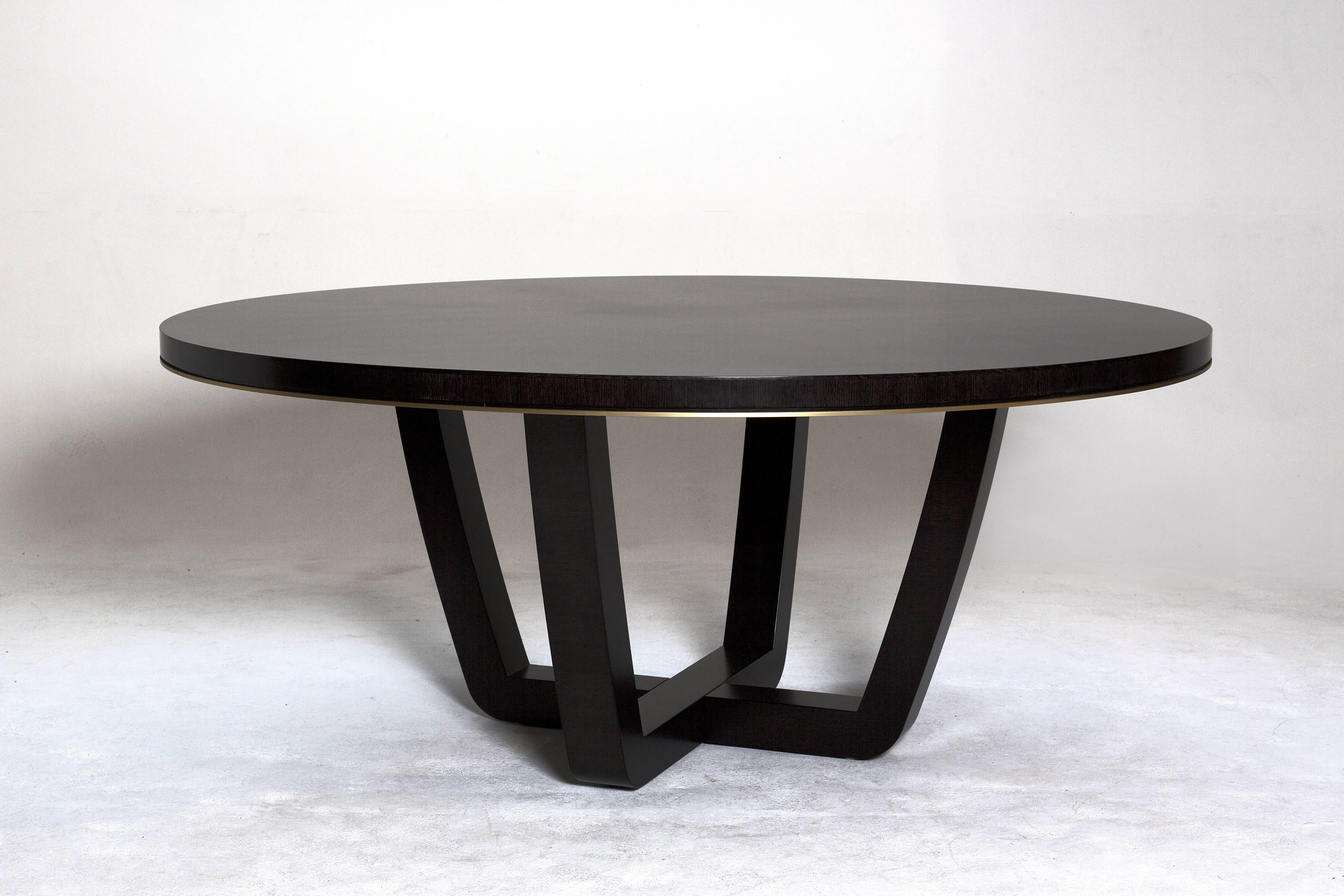 A beautifully understated dining or centre table finished in a semi satin dark tinted quarter sawn oak with a glamorous brushed brass moulding.

A contemporary style with crafted table top and cruciform base. The satin finish offers a modern,