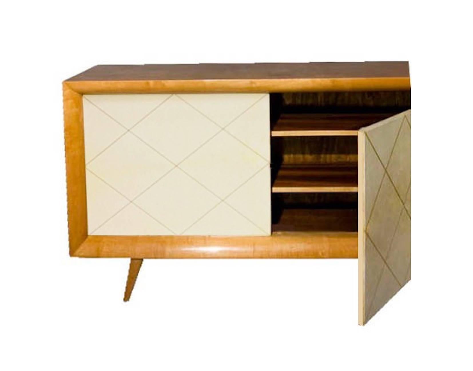 Sideboard in oak and parchment goatskin Suzanne Guiguichon style 1950. 
Clearly inspired by French Art Deco and Modernism, this piece has two doors in warm white/beige parchment goatskin leather, matte finished, with rhombus motif metal inlayed.