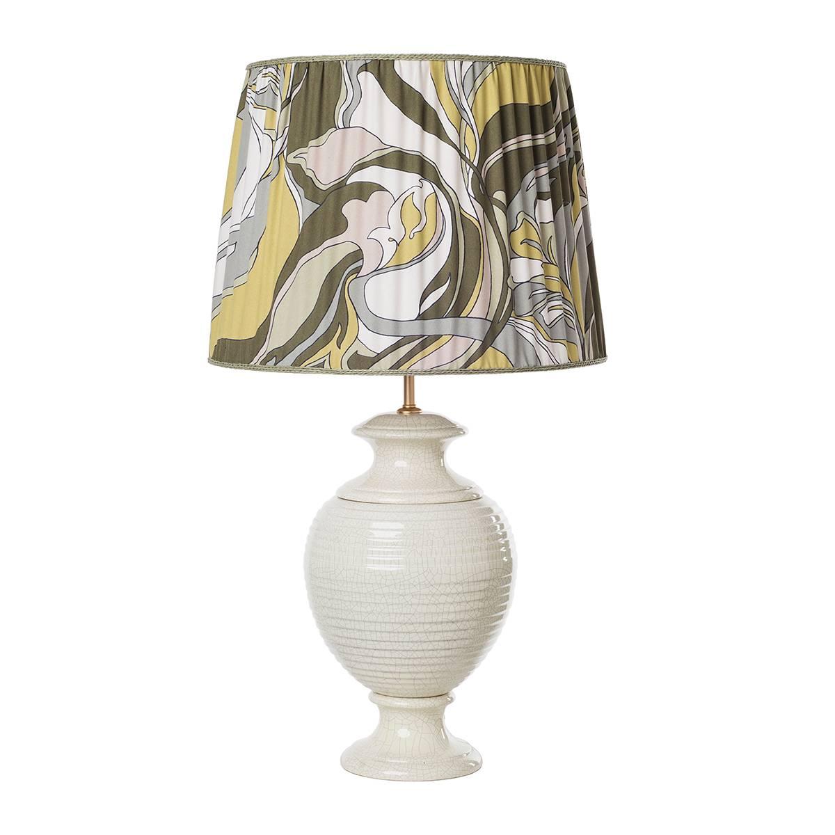 Pair of striped table lamps and shades. The items feature a classical sinuous shape enriched by a crackled ivory glazed surface and completed by a cylindrical pleated shade in a fancy pattern fabric. Wired to your request, 1 x E27/E26 screw bulb.