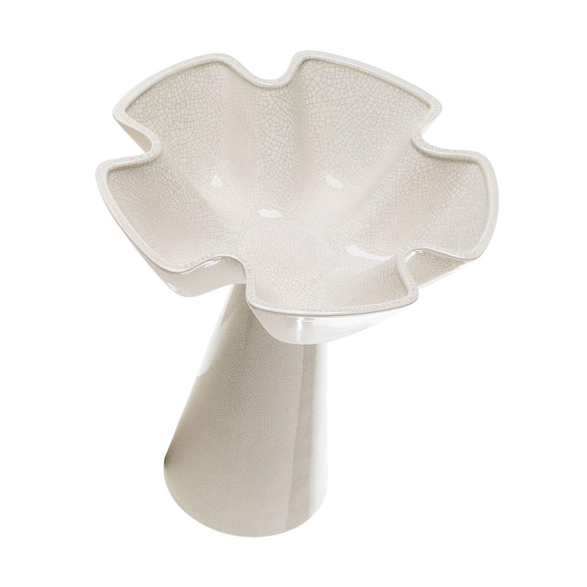 Pair of ceramic floral-shaped centerpieces.
These centerpieces are featured by an off-white crackled glaze hue and from a floral steam raising its petals to sky. A skillfully handcrafted creation for a fresh touch in any space.