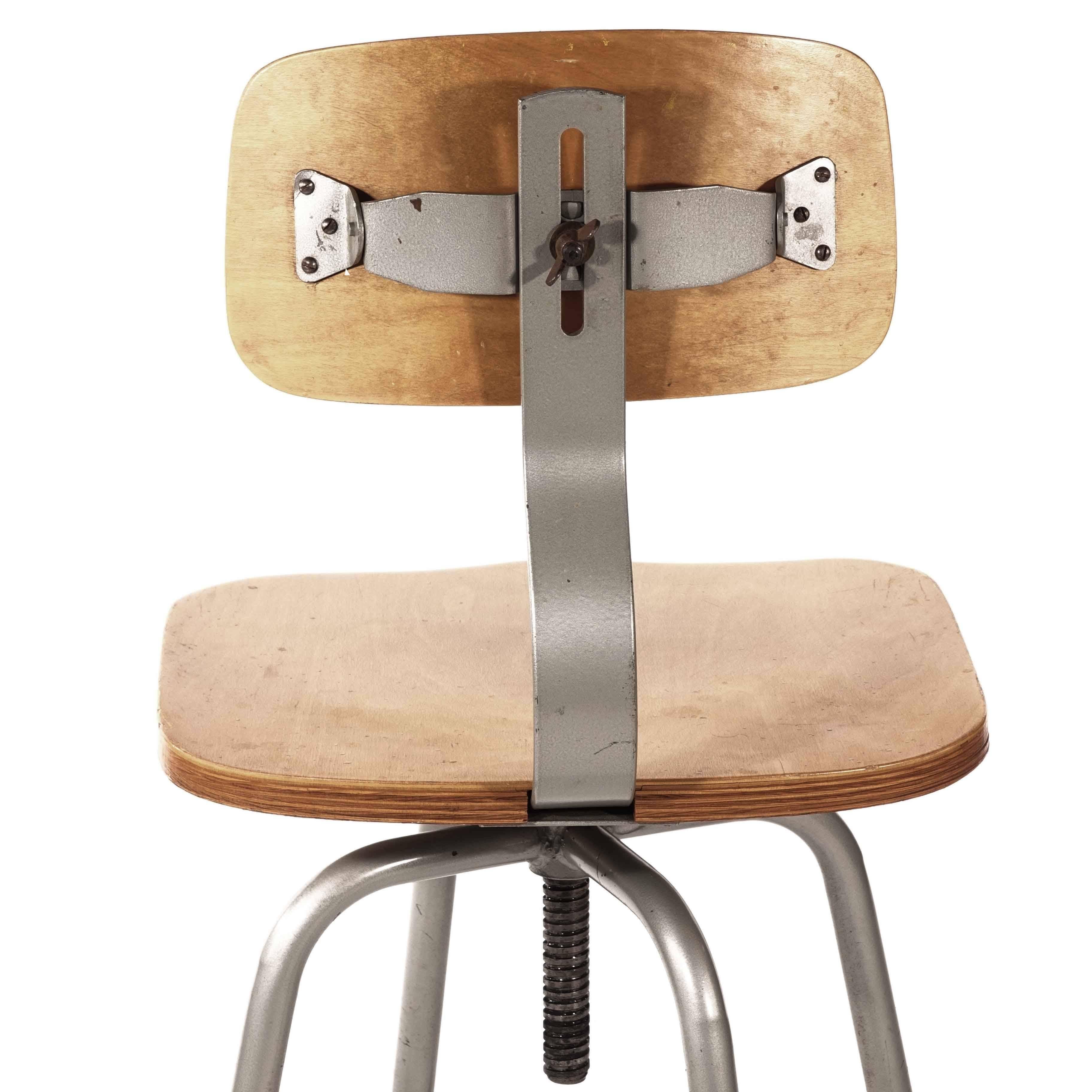 Industrial chair, Sweden, 1940-1950, molded seat and back made of wood, steel frame with adjustable height of the seat, this type of chair was common at the machines in the Swedish metal industry during the 1900s.
 