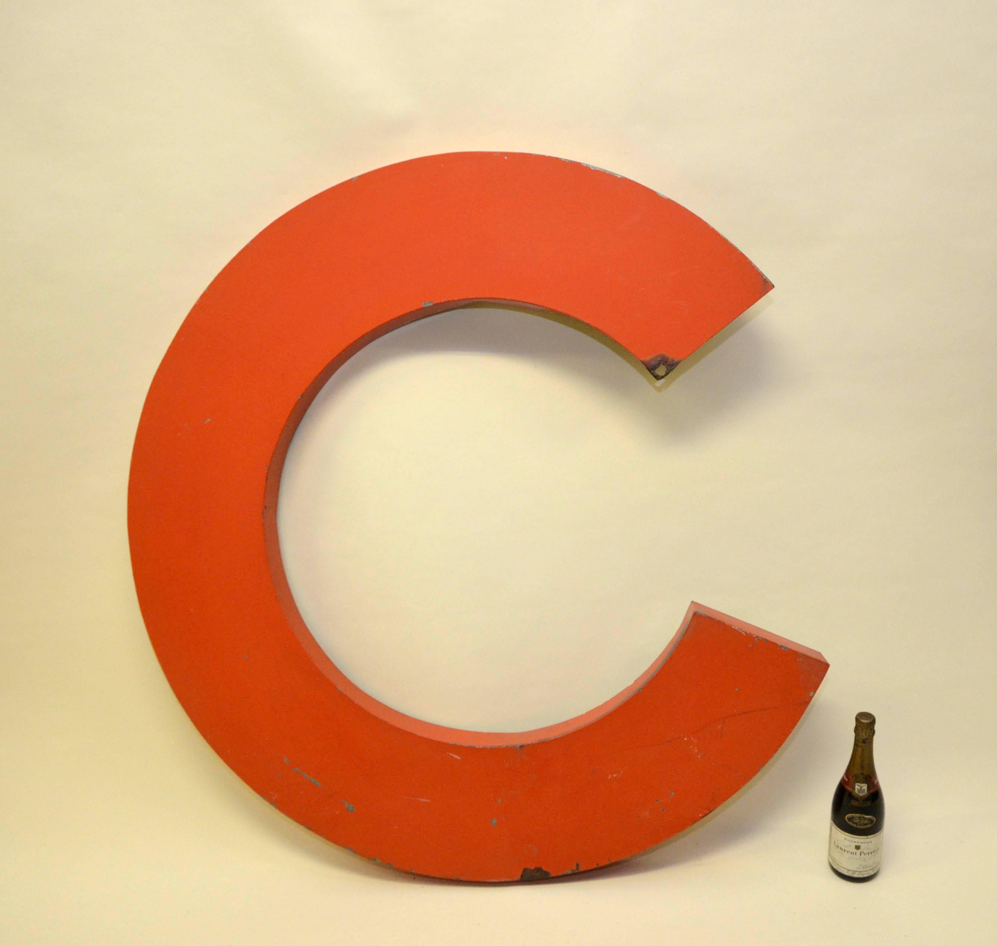 Very large orange capital letter C from French Citroën sign.
From the same sign also available in stock letters: I,T,O,N.

Collector's note:

Citroën is a major French automobile manufacturer. In the 1950s car dealers in France had large signs on