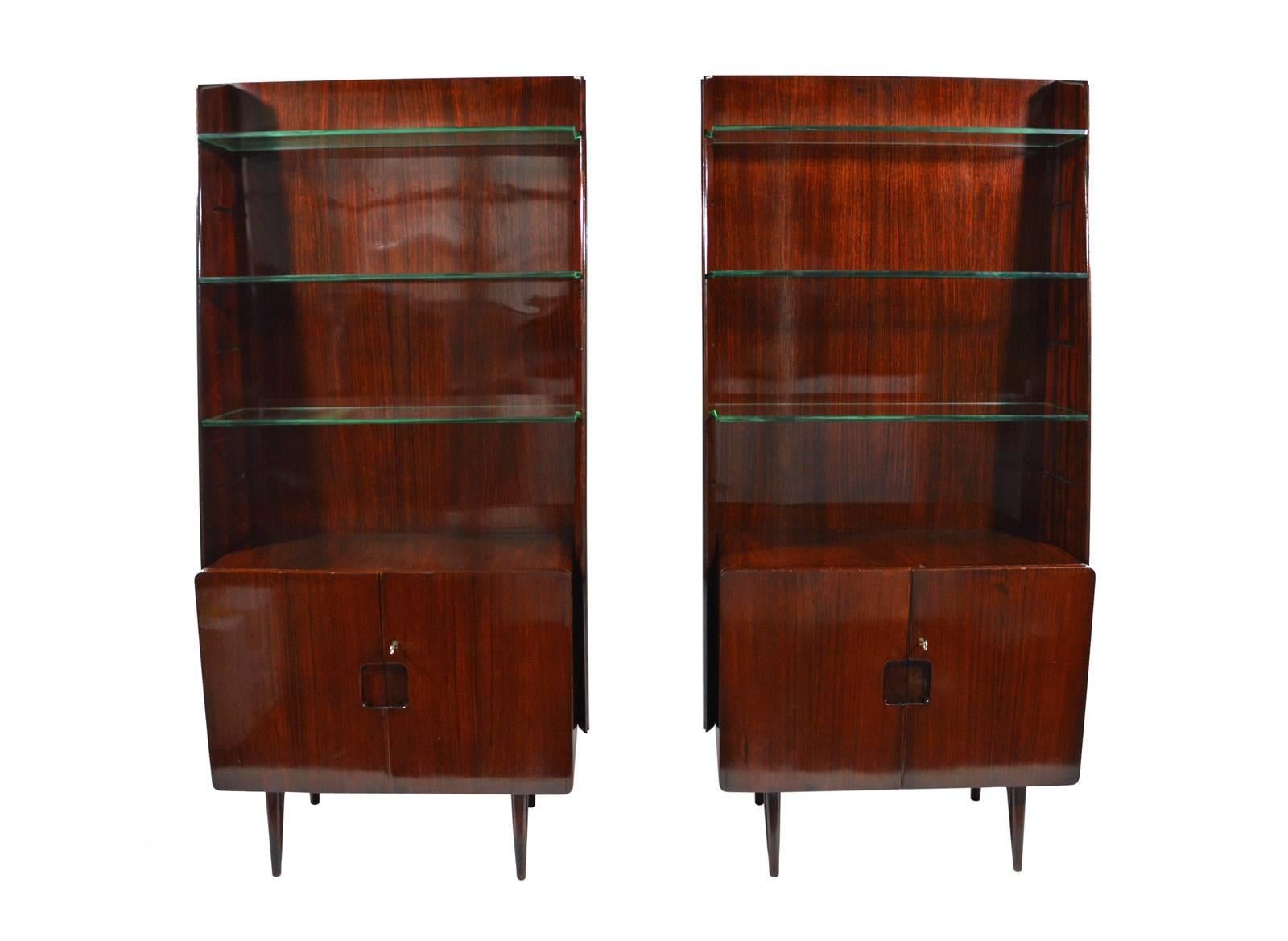 A pair of mahogany bookcases with glass shelves designed in 1950s by Franco Cavatorta for his family's firm, Silvio Cavatorta, based in Rome.
In good original condition, with some signs of age visible in the photos, marked with metal