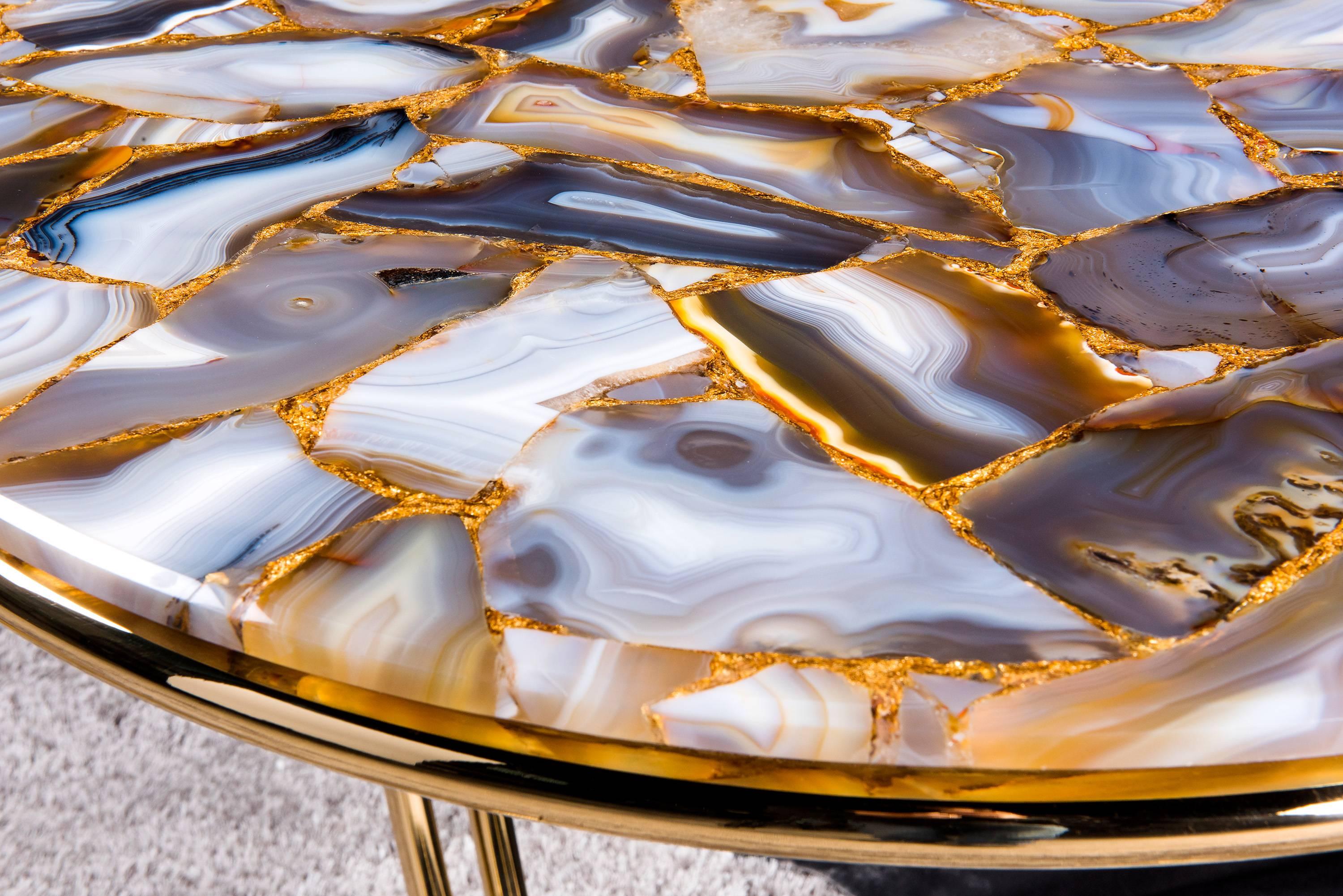 A luxury side table with massive stainless steel galvanished-gold polished tubes. The visible edge of the semi-precious stone Agate Rubane with gold top is reduced to 1cm to give it an elegant look. The 60 cm height matches perfect with a