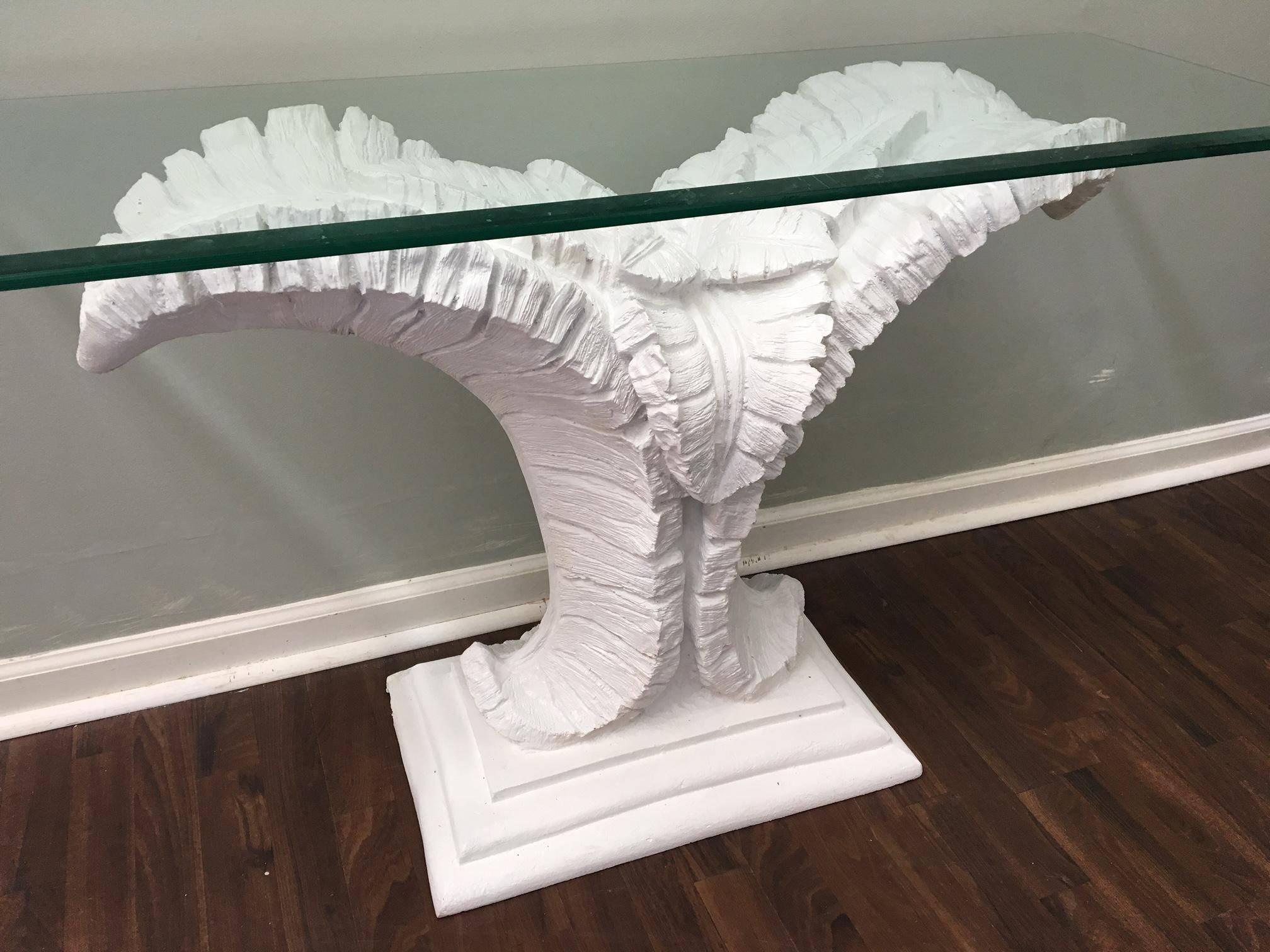 Console table sculpted in form of large palm leaves. In the style of Serge Roche or Dorothy Draper. Console features dramatic tropical tree designed pedestal with a glass top. Molded in a heavyweight composite.  Excellent vintage condition