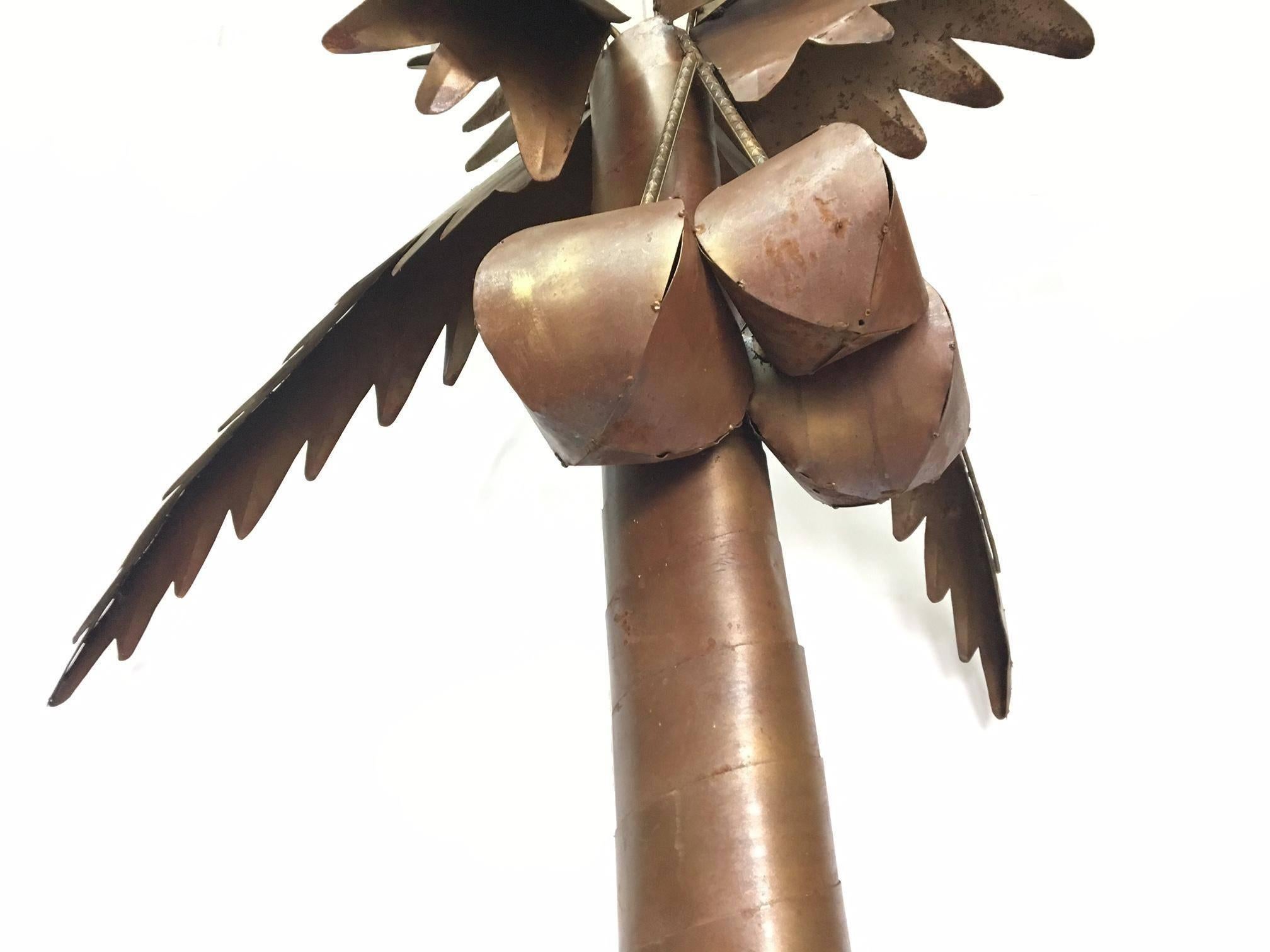 Large steel palm tree sculpture stands over 8 feet tall. Frawns can be detached for easier moving. Finish is burnt gold and brown, with some natural oxidation and patina. Thin sheet steel with steel rebar inner frame. Could be used indoors or out.